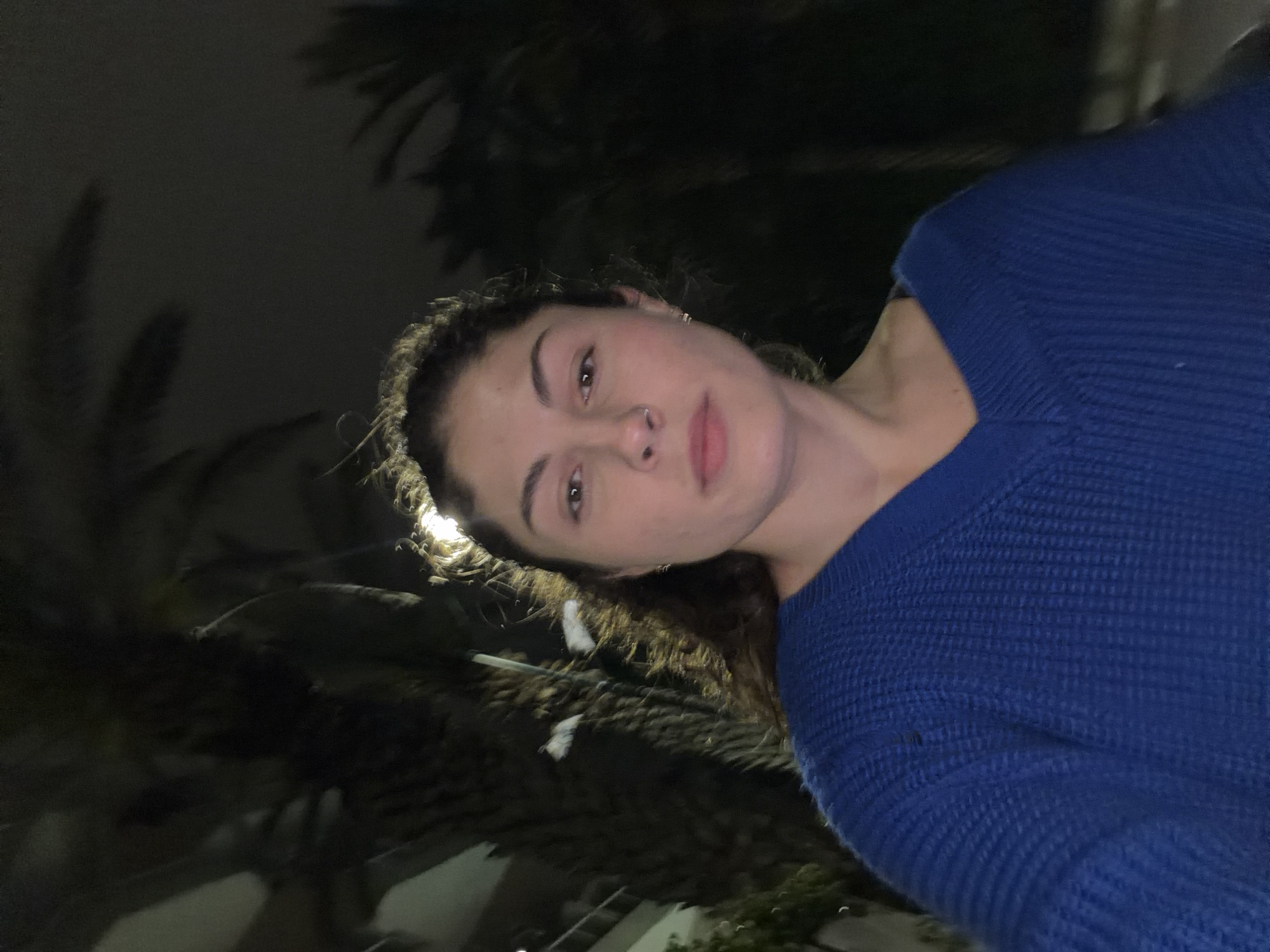 Woman photographed in blue sweater at two Kiryat Bialik locations