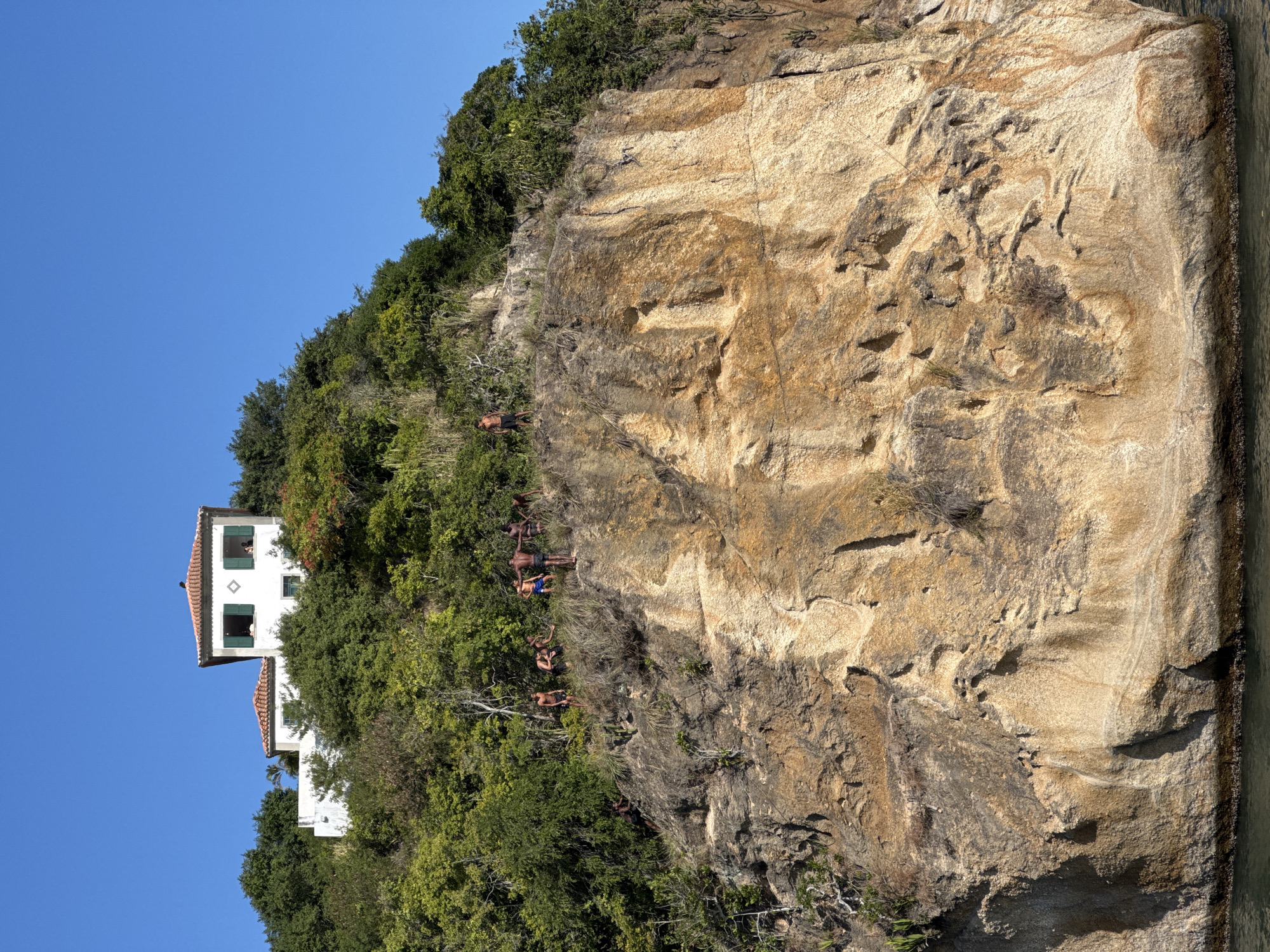 Cliff jumping off Niterói's rocky coastline