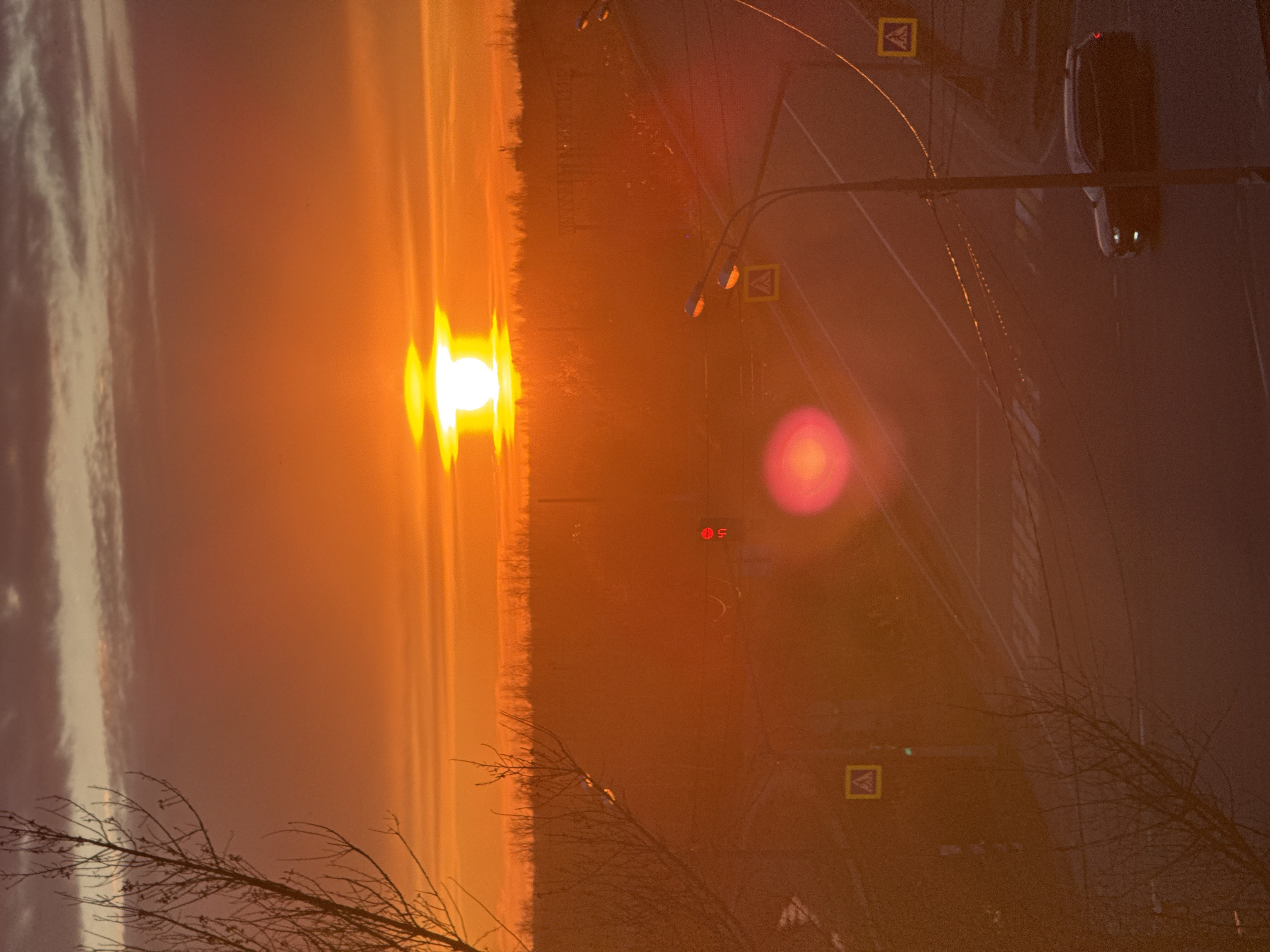 Sunset observed over Ново-Никольское with road traffic visible