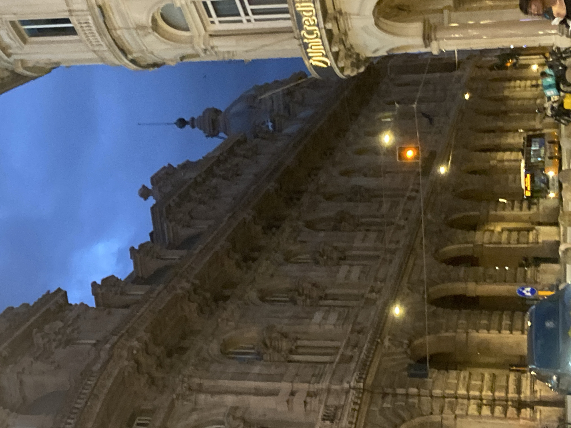 Genoa's Piazza de Ferrari at dusk, fountains lit and running