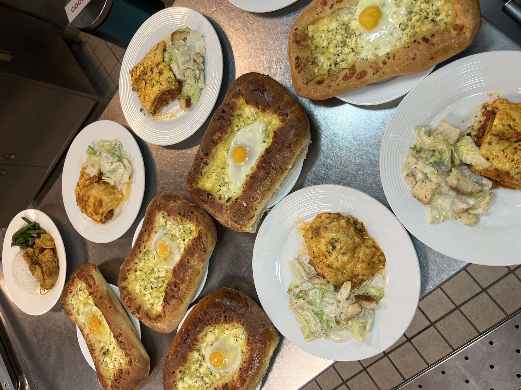 Prepared dishes arranged on commercial kitchen counter