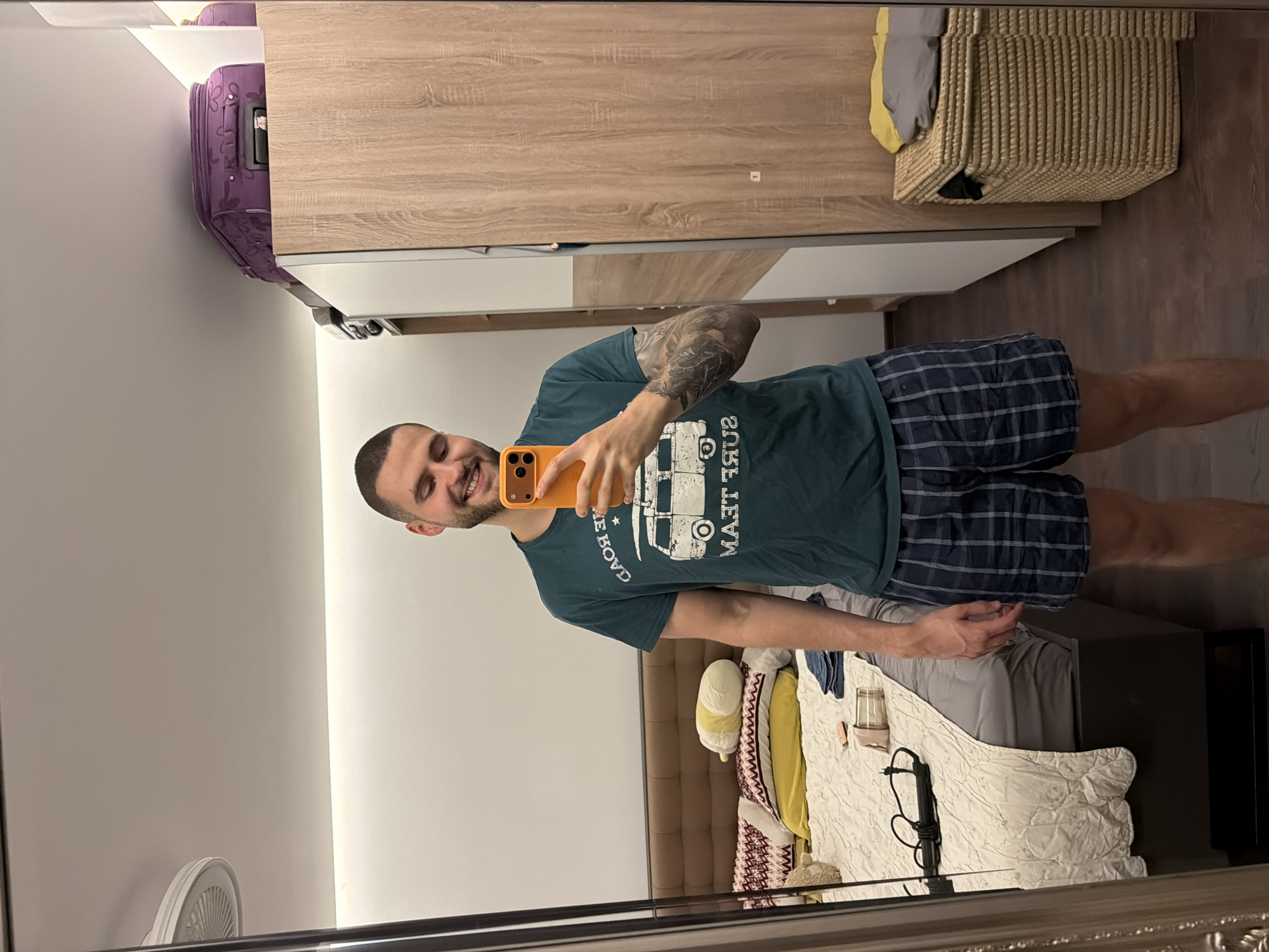 Couple takes multiple mirror selfies in Sofia bedroom