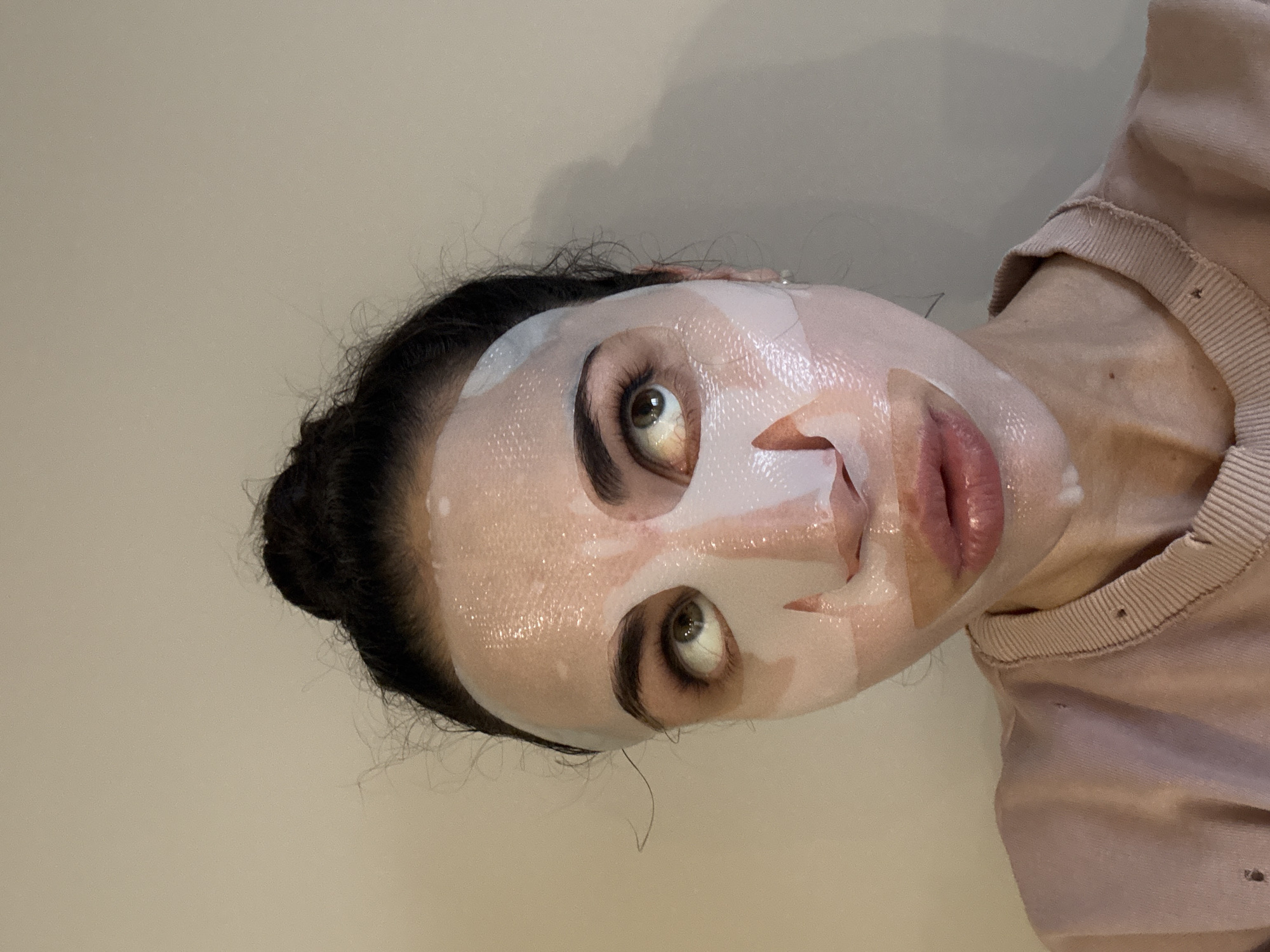 Woman applies face mask in Moscow indoor setting