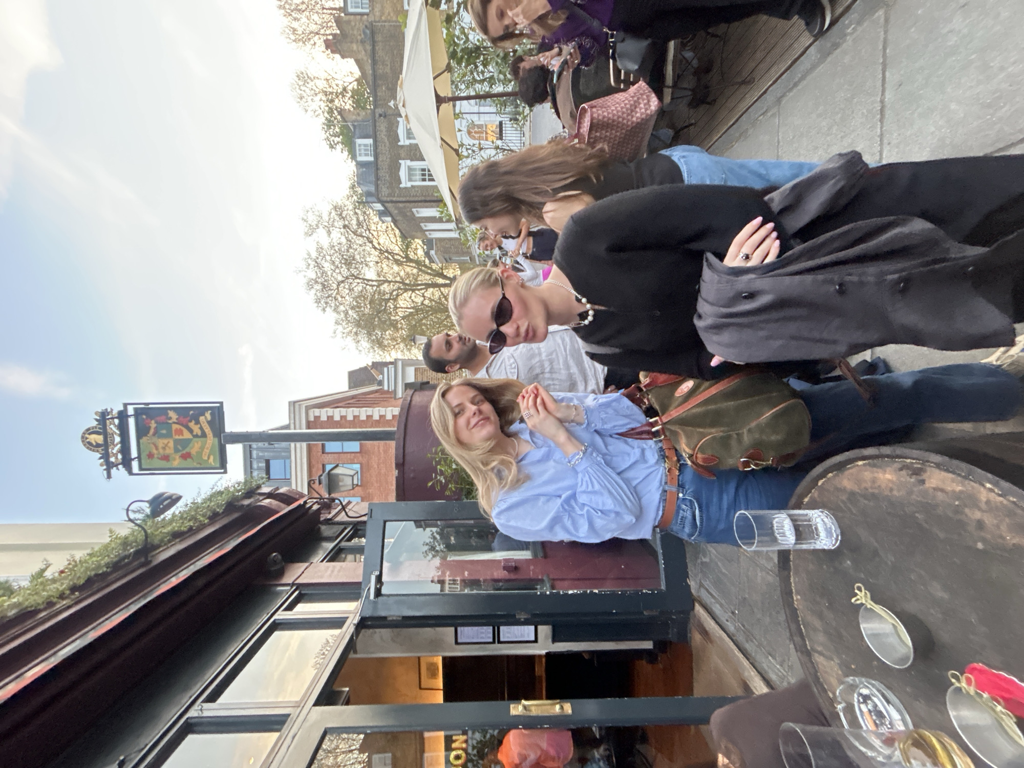 Woman seated at outdoor table during London gathering