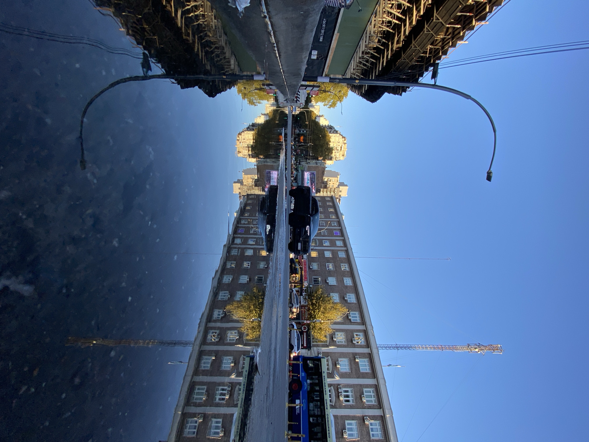 Building reflection captured in Buenos Aires street water