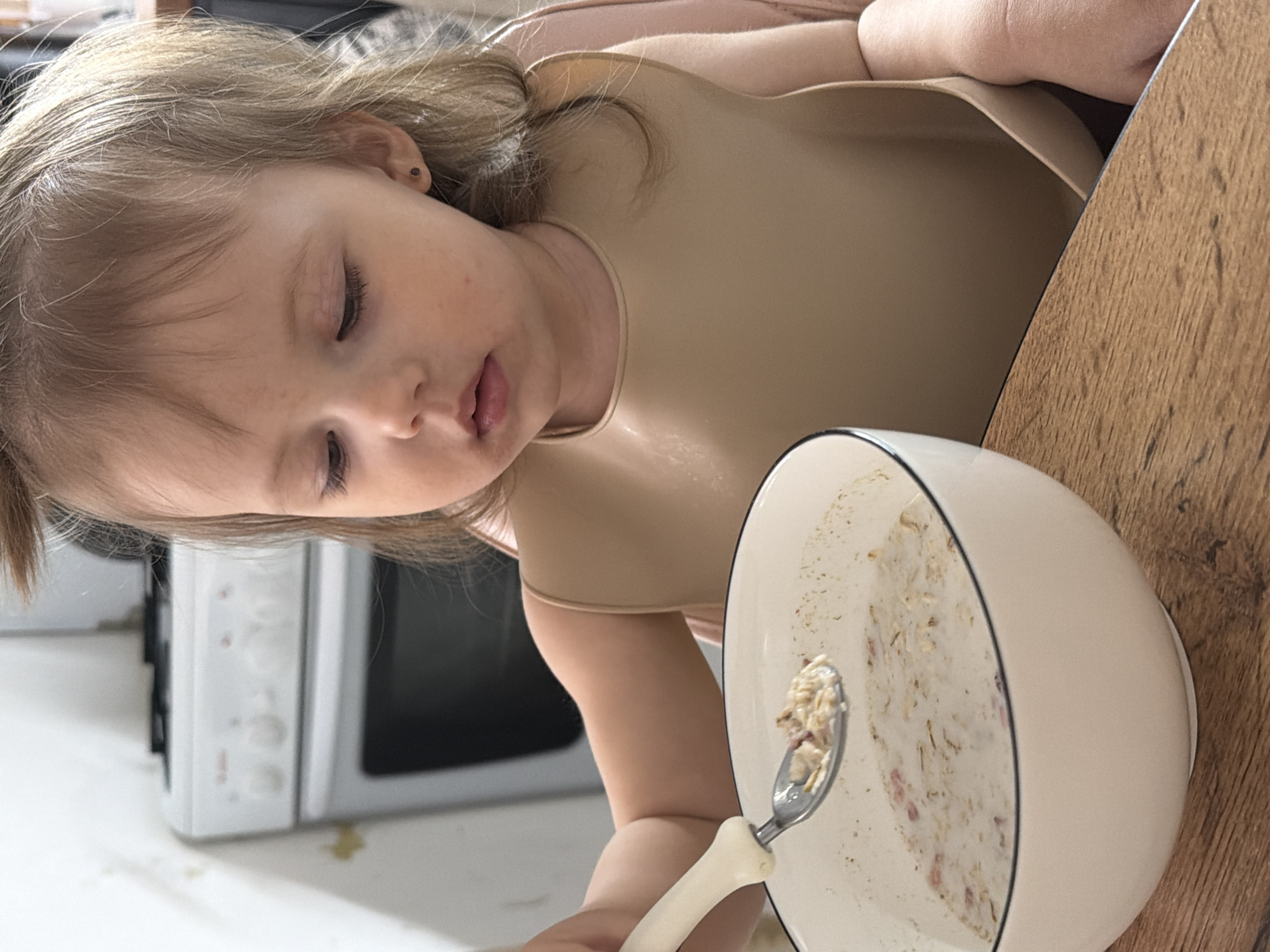 Child enjoys breakfast cereal in Reshetnikovo, Russia