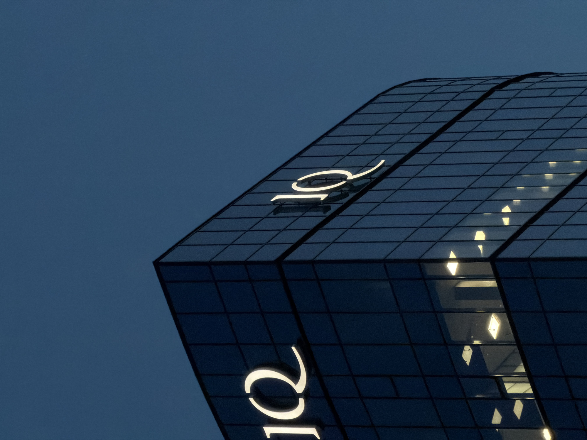 IQ Business Center glows against Brest's twilight sky