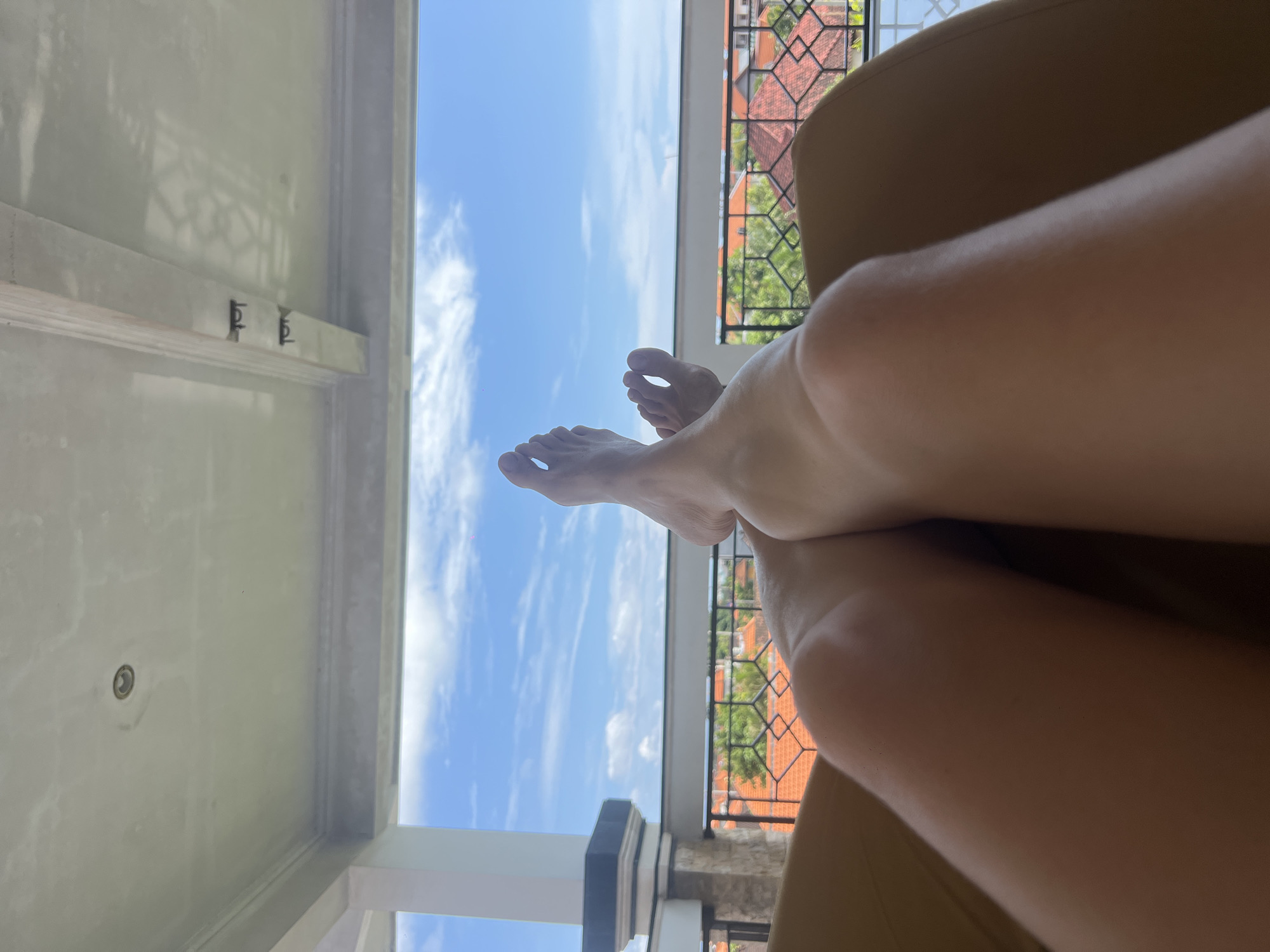 Morning relaxation captured on Canggu balcony with pet