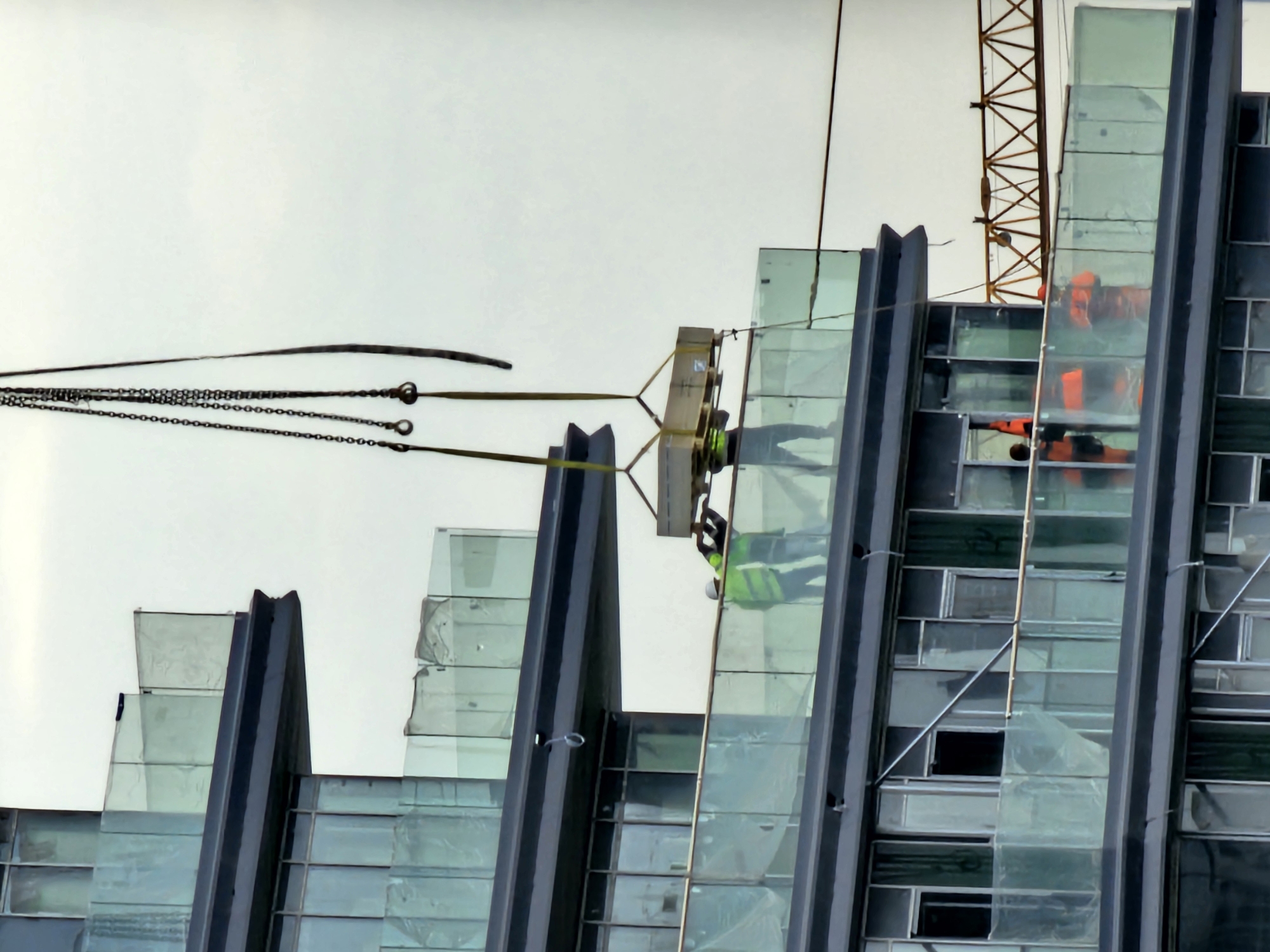 Crane lifts materials to upper floors at Moscow construction site