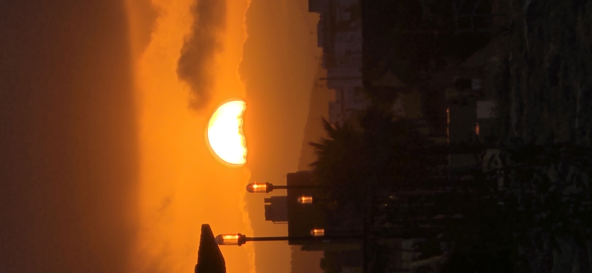 Evening beach activities documented during dramatic sunset in Sagunto