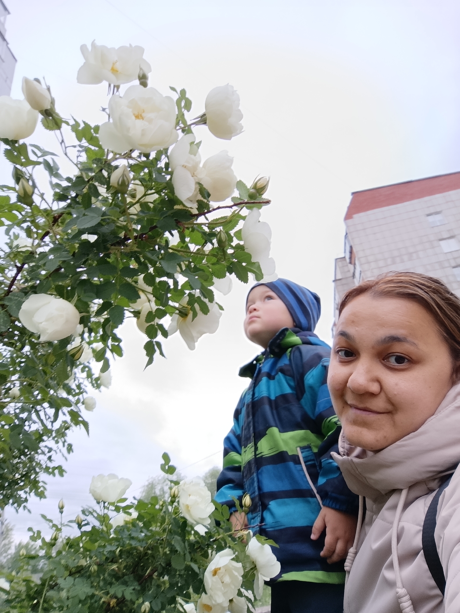 Mother and child enjoy puddle play in Chaikovsky, Russia