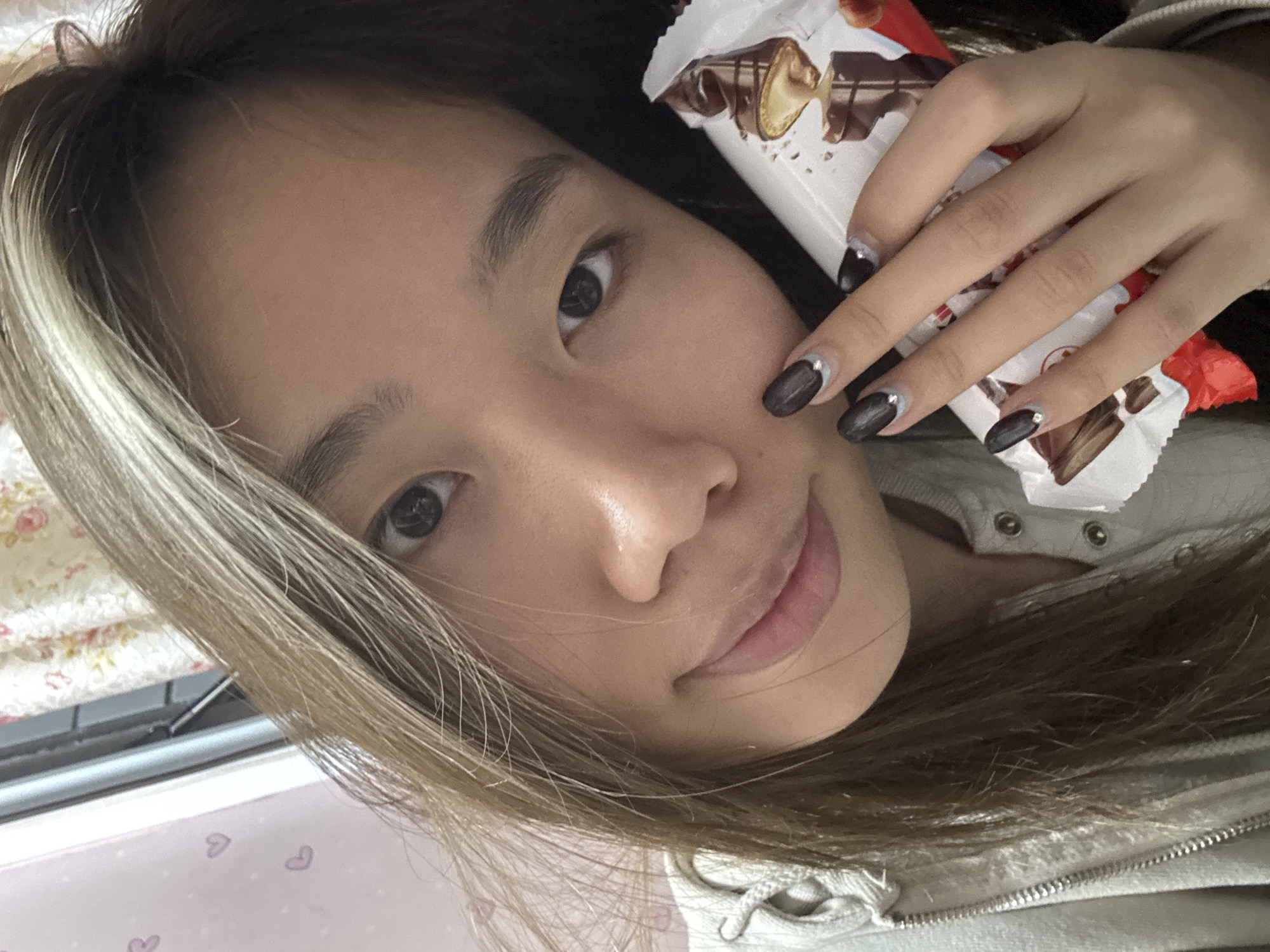Woman takes morning selfie session in Chongqing bedroom