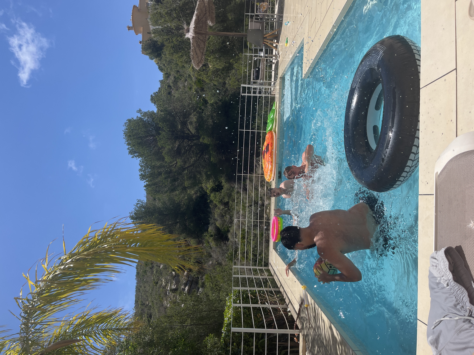 Young men enjoy pool games in Spanish coastal town