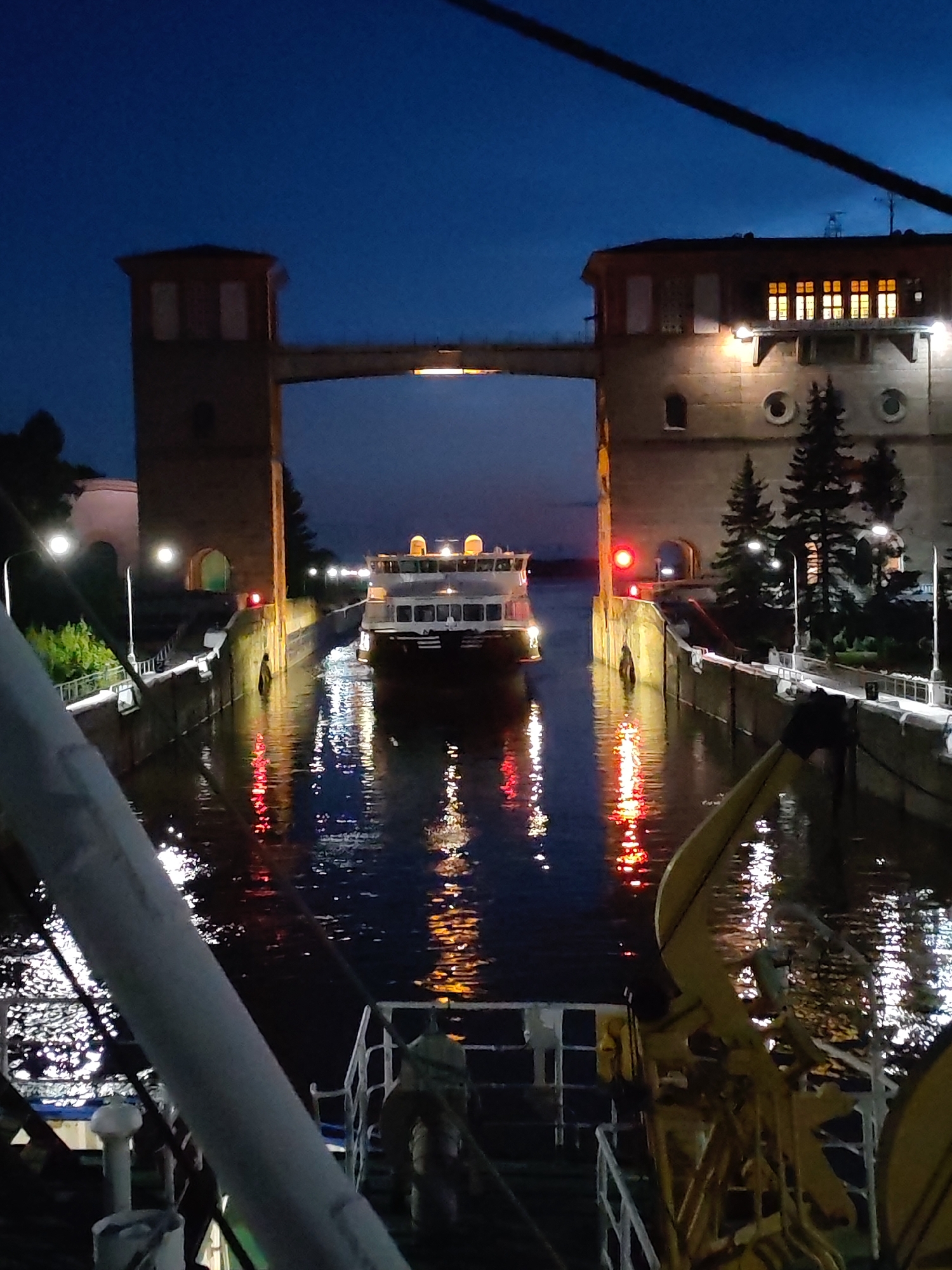 Nighttime waterways: locks, a lighthouse, and moonlit water