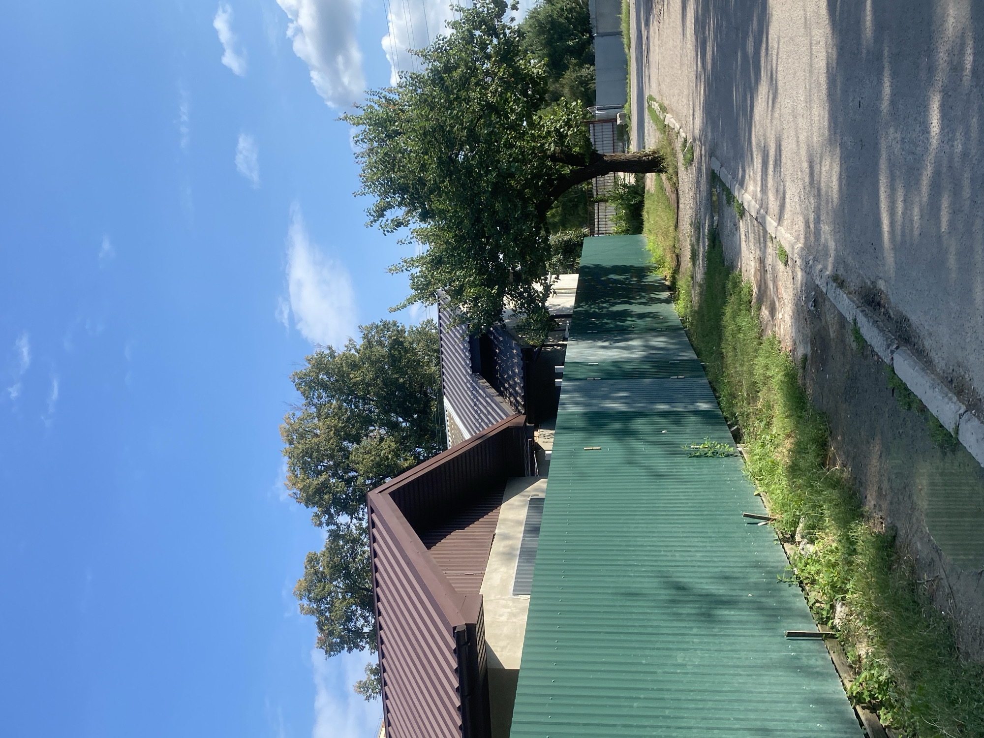 Quiet residential street in Poltava on a sunny post-rain afternoon