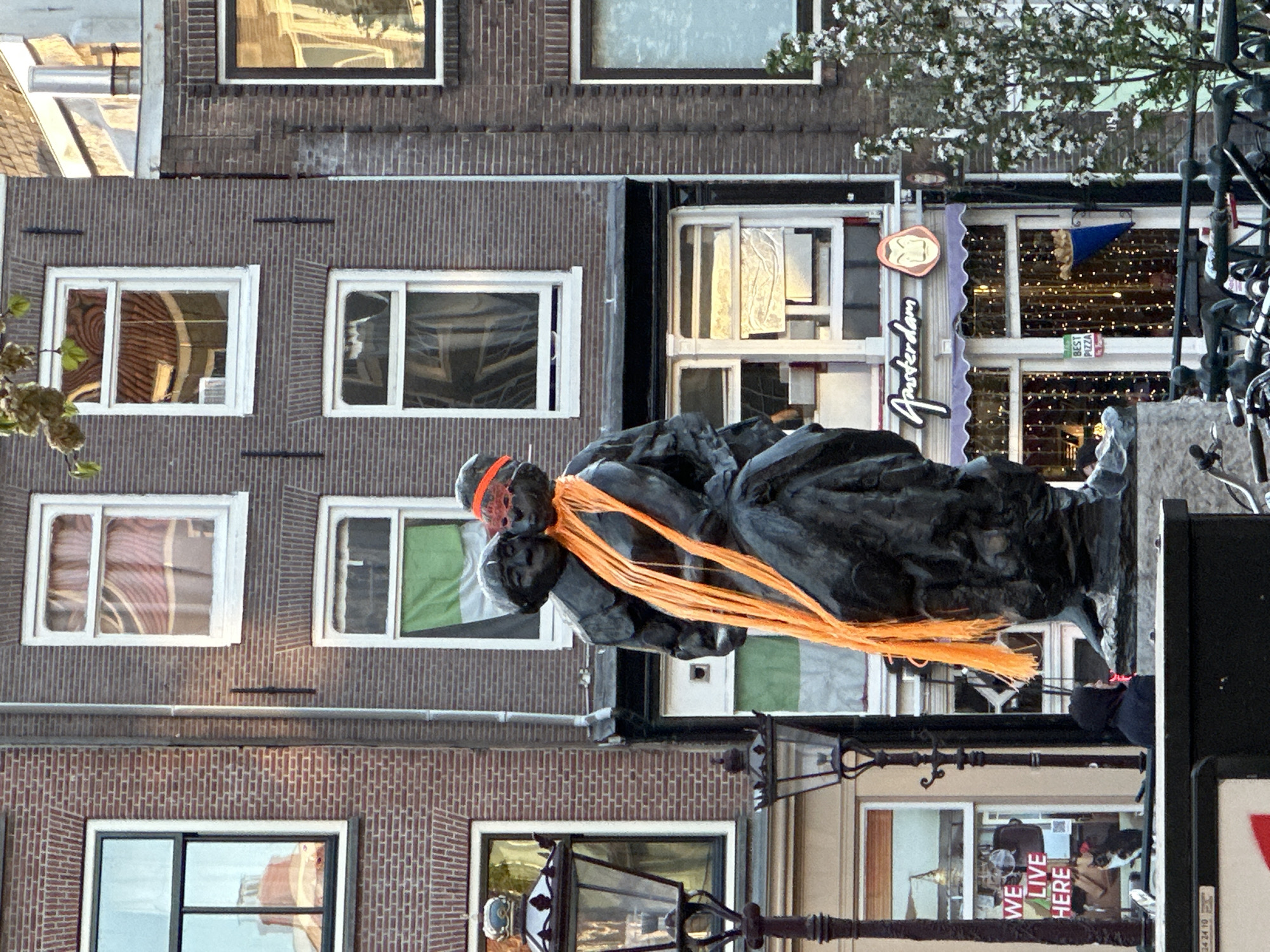Anne Frank statue with orange ribbons spotted along Amsterdam canal