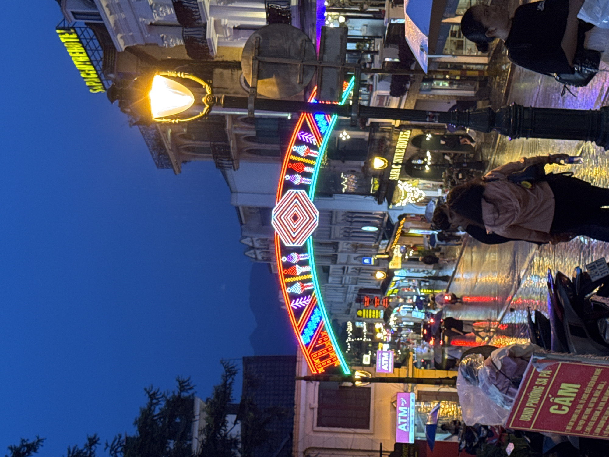 Sa Pa's Sun Plaza glows at dusk beneath neon lights