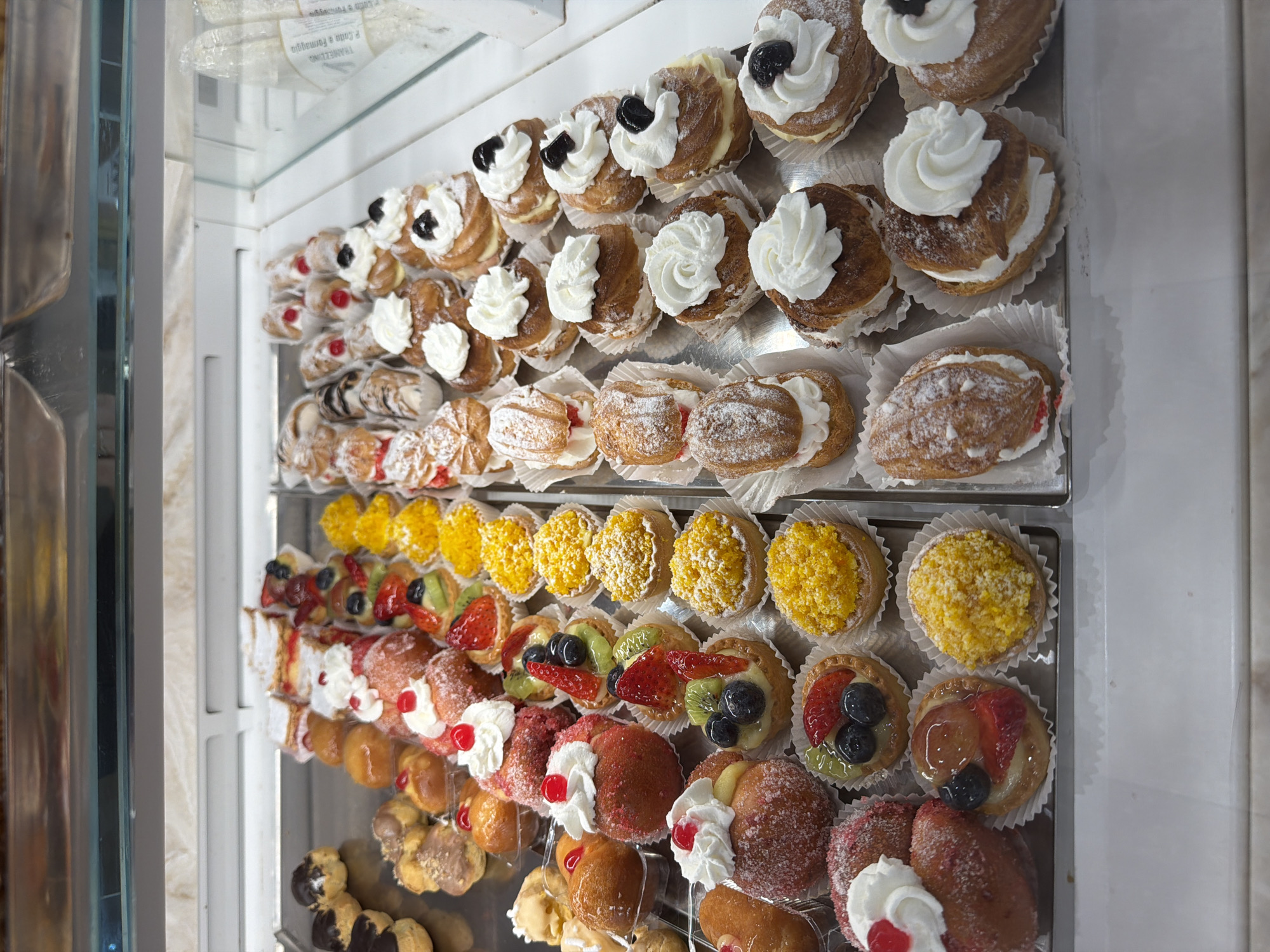 Italian bakery displays pastries and coffee roasting operation in Tarquinia
