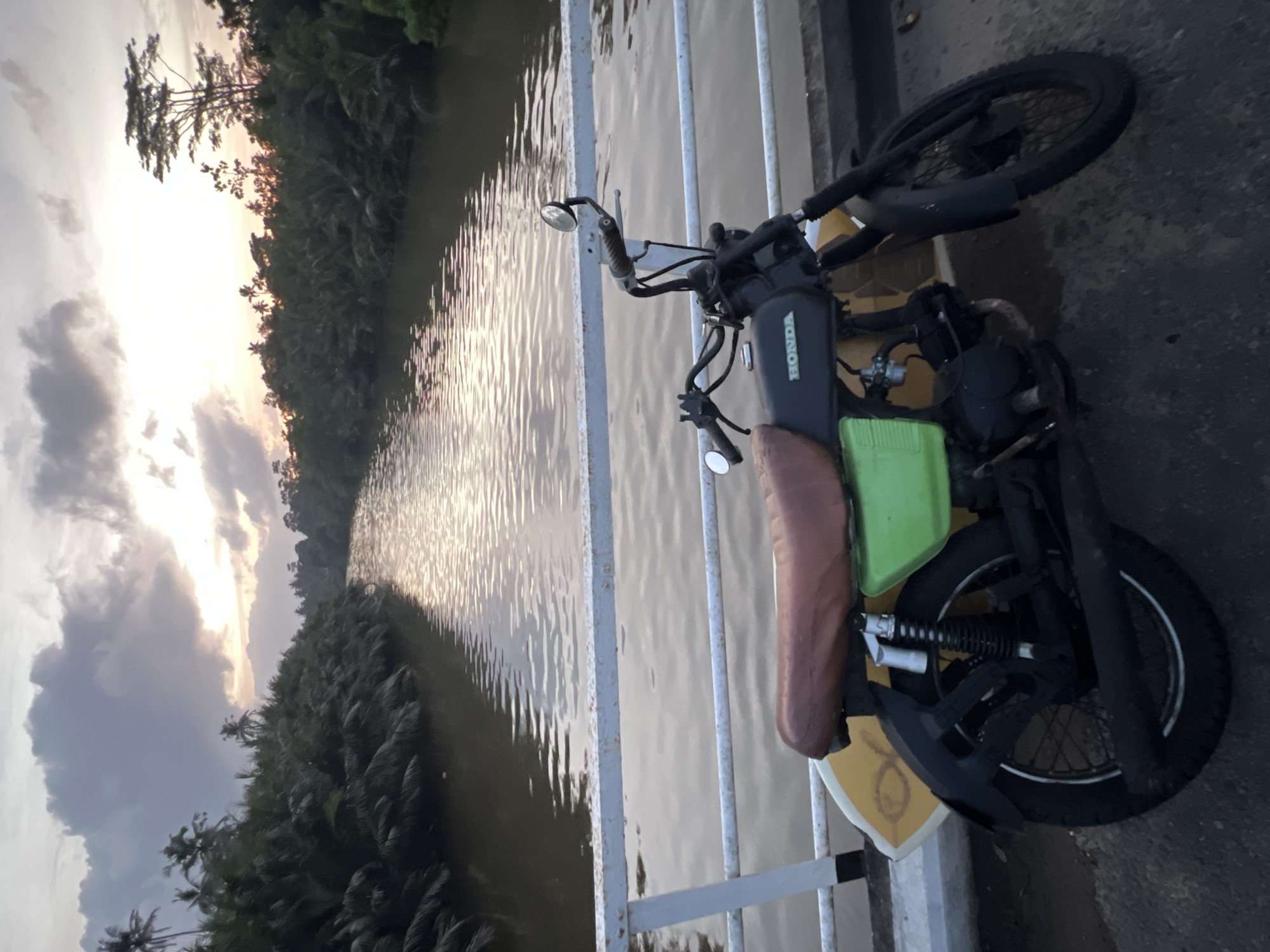 Sunset river views and motorcycle surfboard setup in Sri Lanka