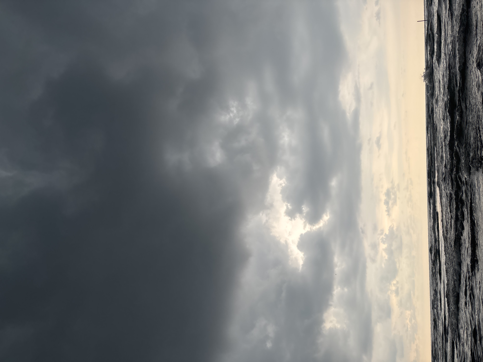 Beachgoers witness dramatic storm clouds in Angkleng Barat, Indonesia