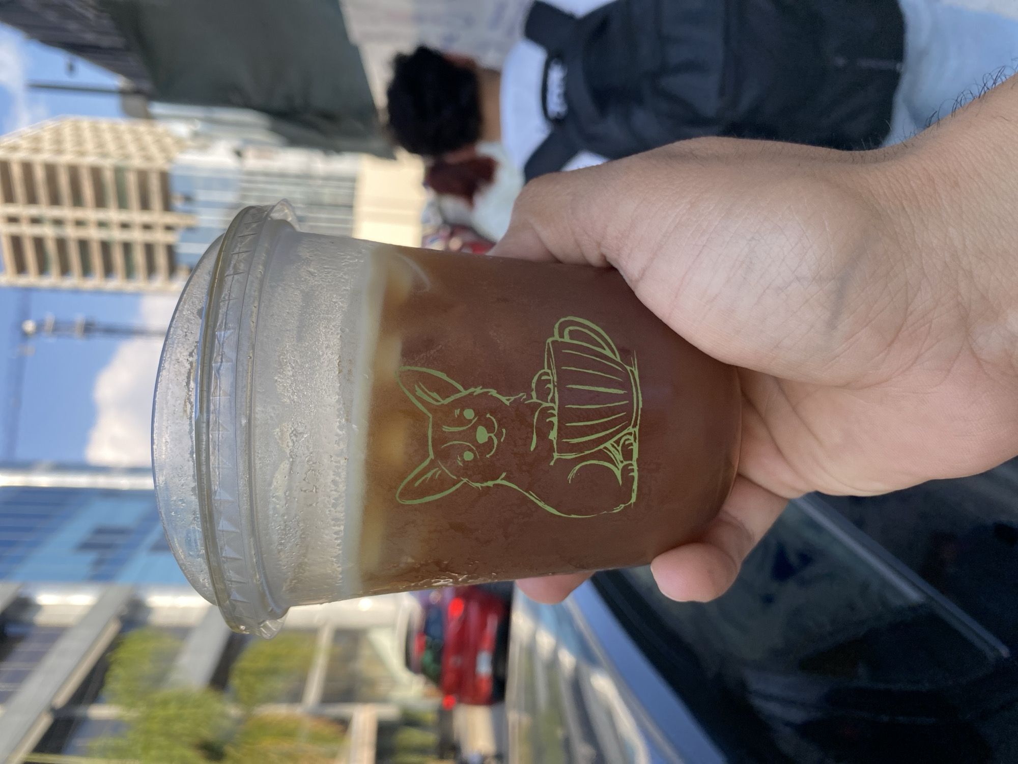 Cold brown beverage with foam served in decorated cup in Puebla