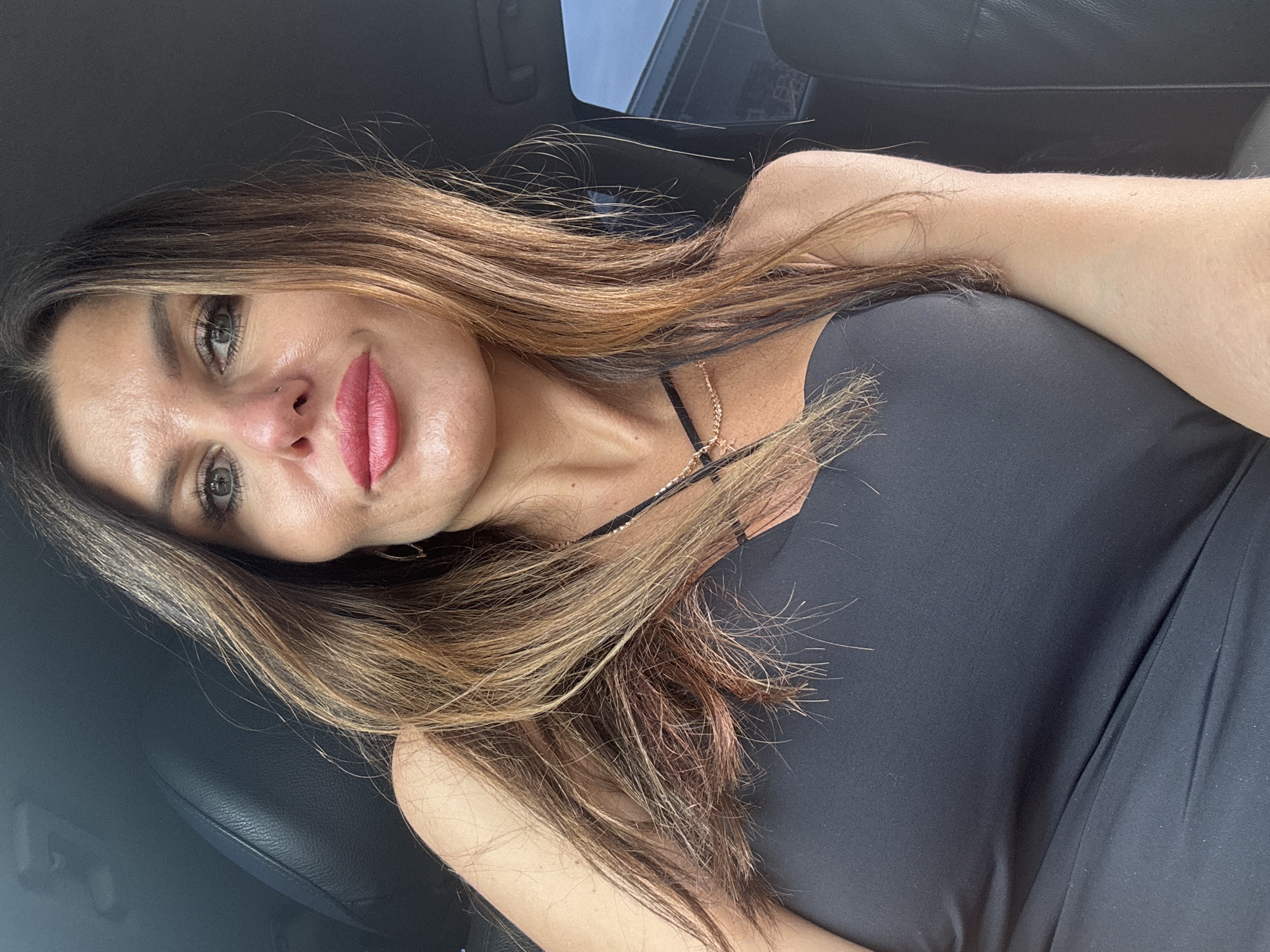 Woman takes car selfies, man grills outdoors in Chaikovsky