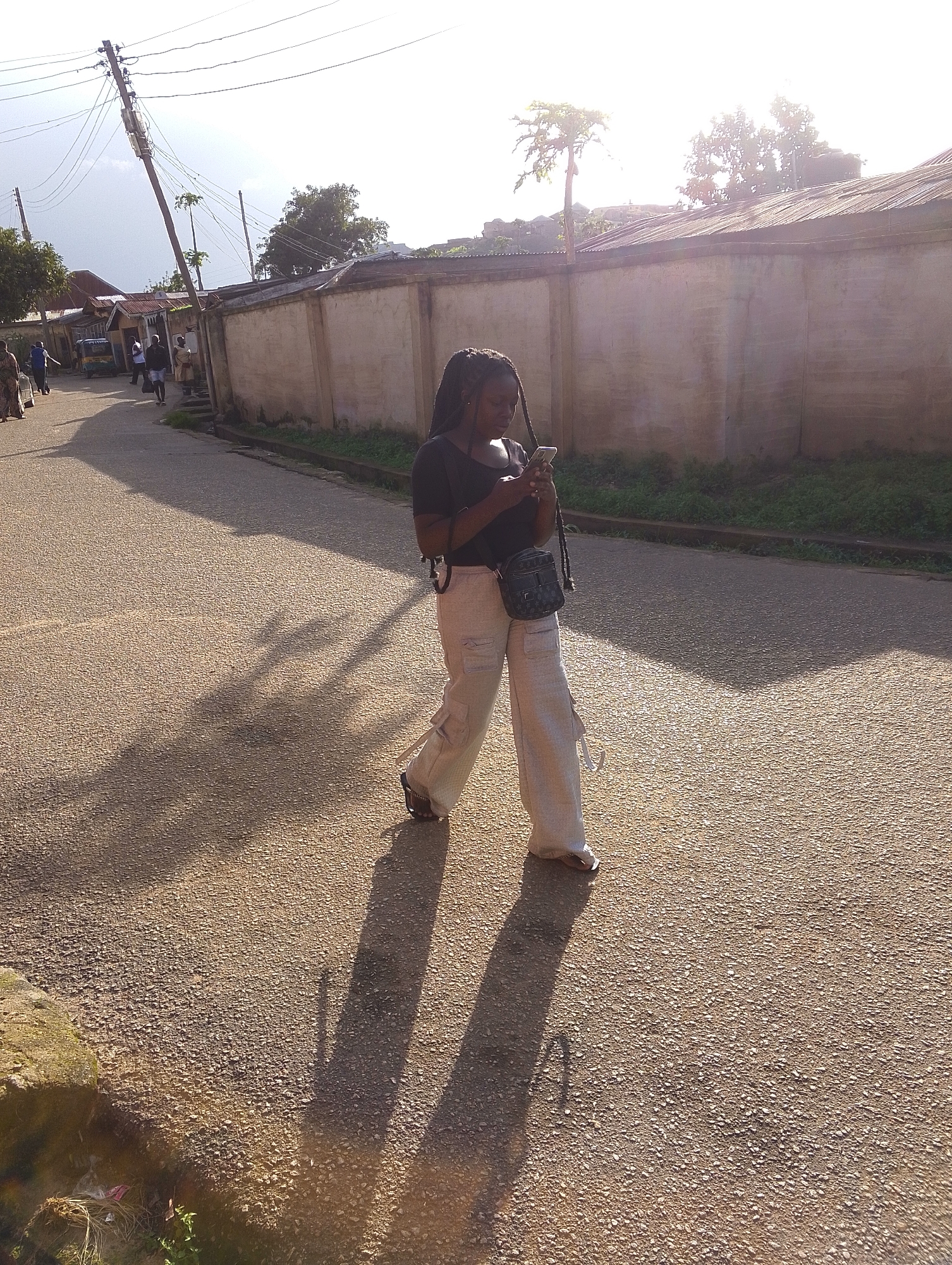 Afternoon street life along a Jos, Nigeria neighborhood