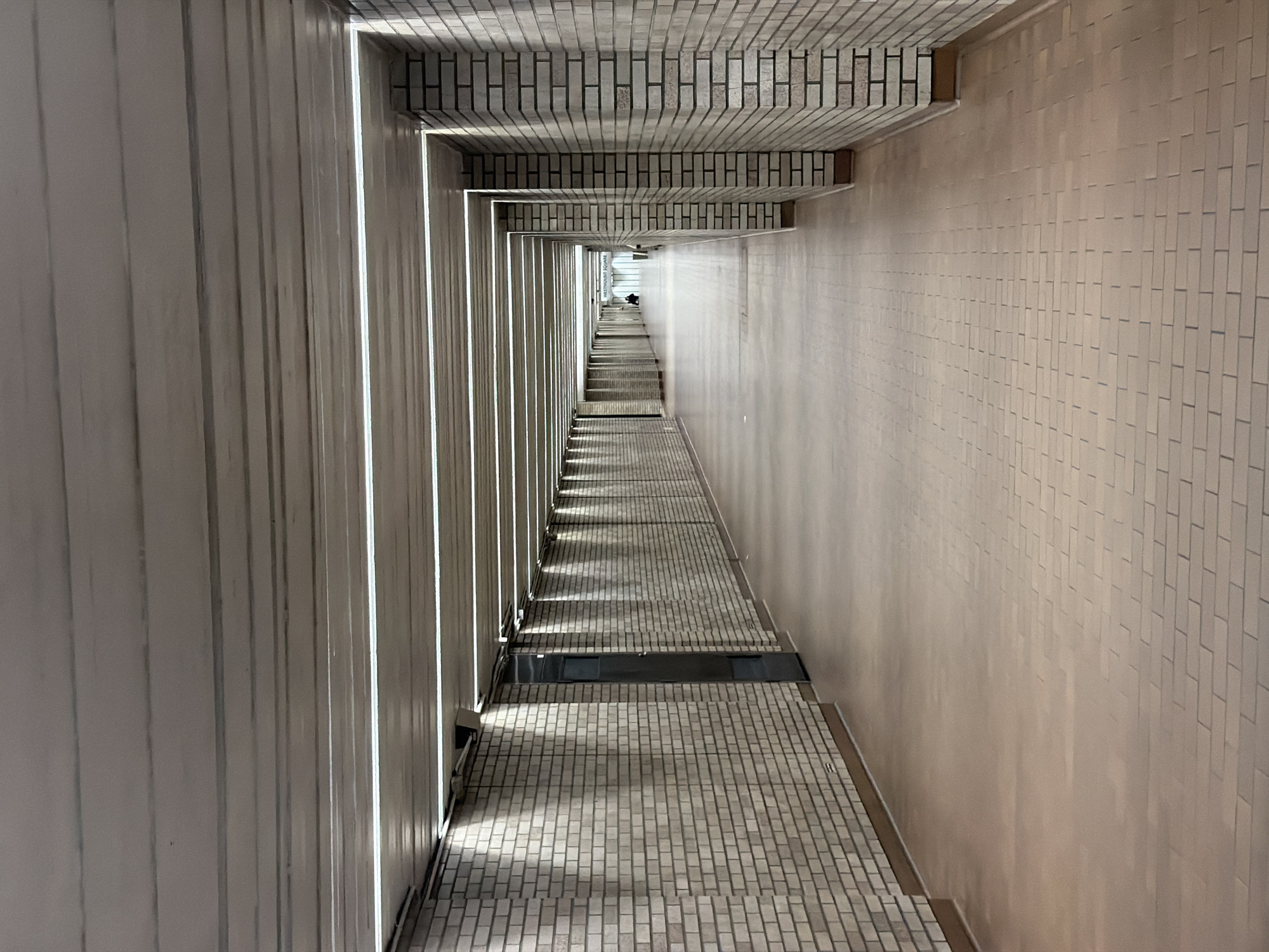 Tiled corridor with receding perspective documented in Montreal