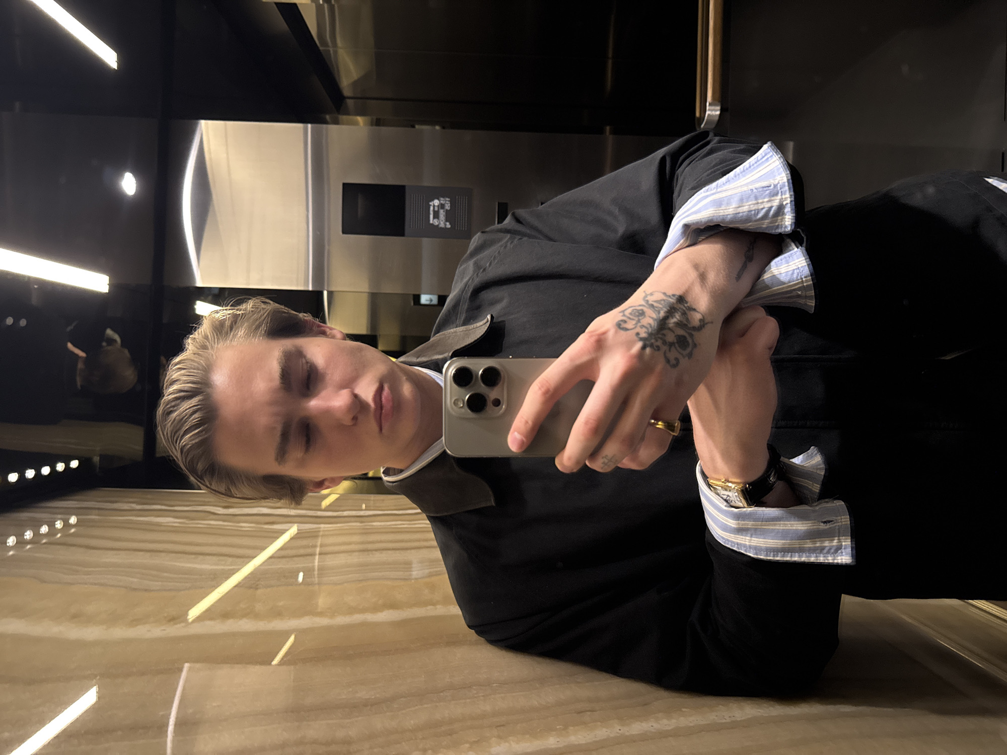 Young person takes selfie in upscale London building