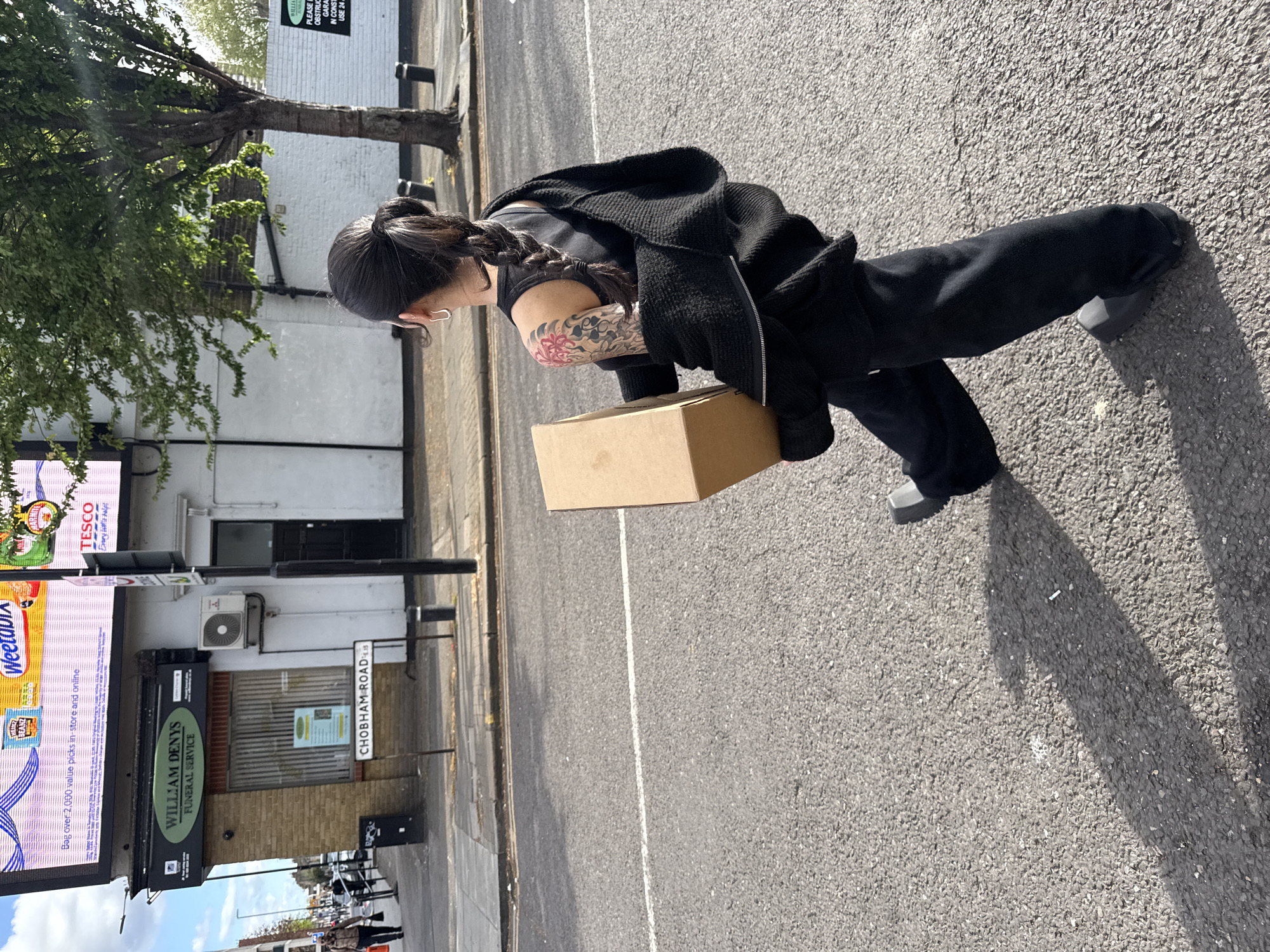 Woman with cardboard box spotted on London's Chobham Road