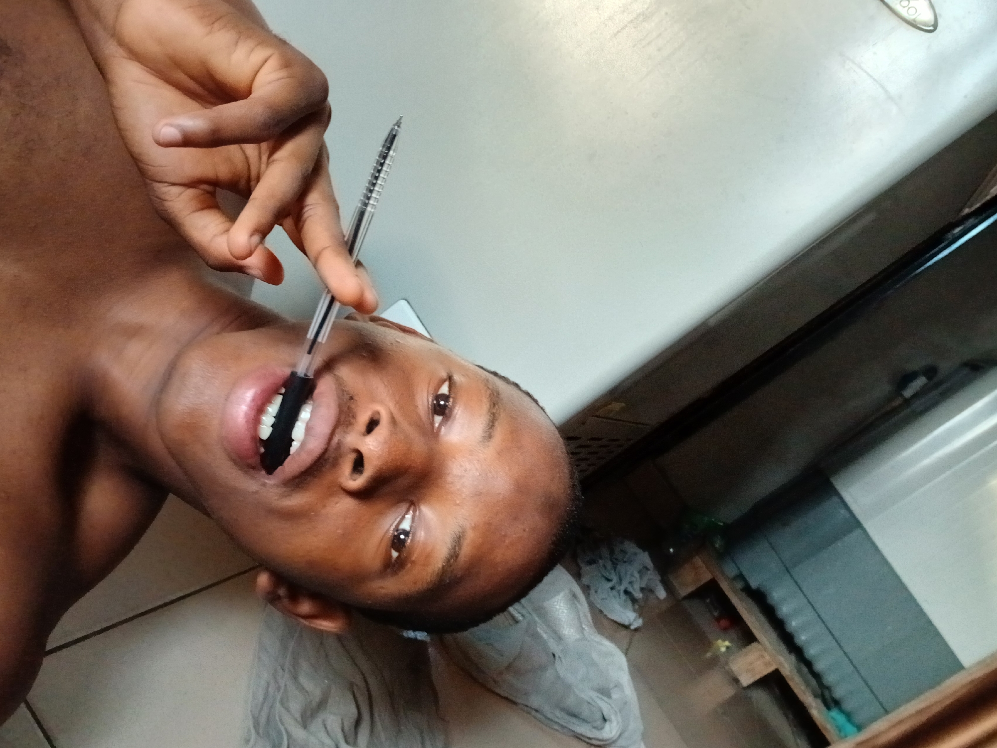 Man photographed in casual morning moments on bed in Lagos
