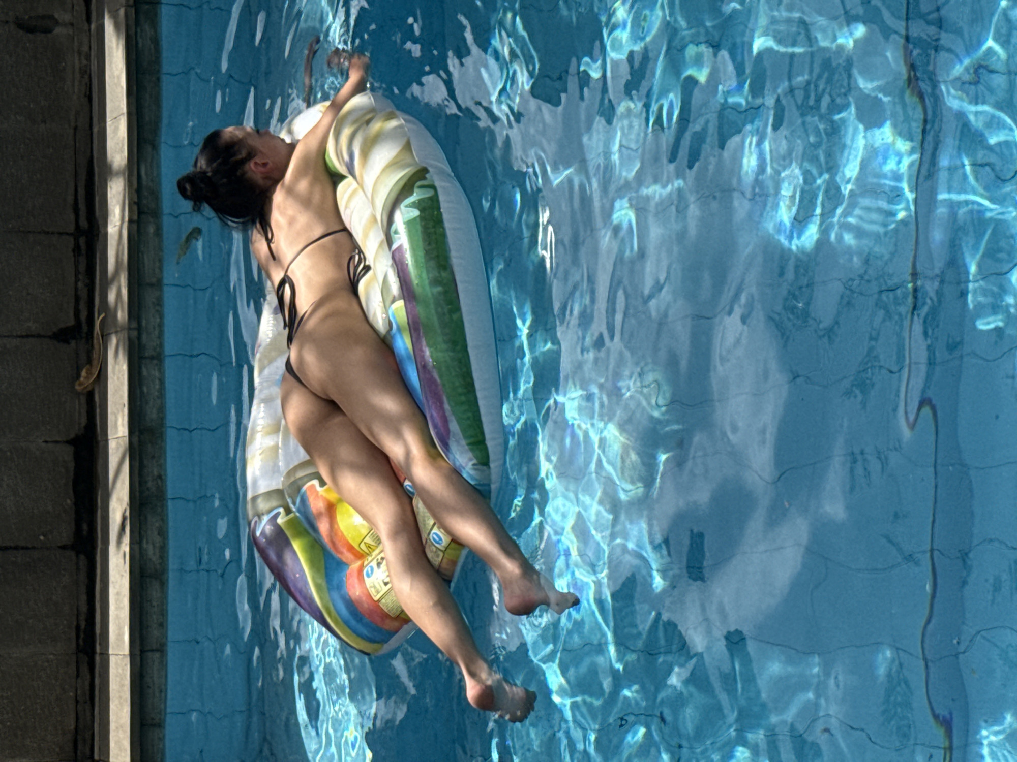 Woman relaxes on pool float in North Kuta