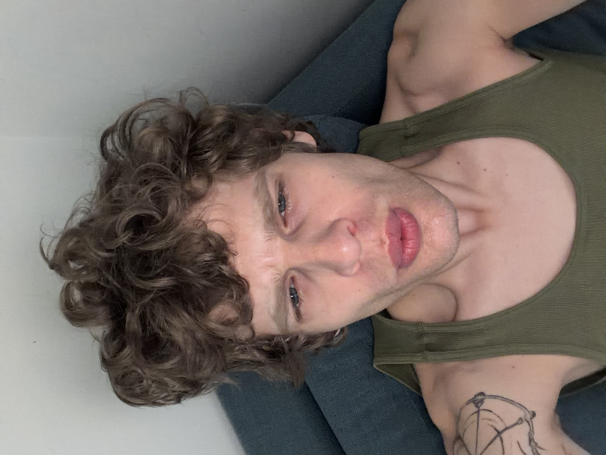 Man in green tank top observed resting in Milan