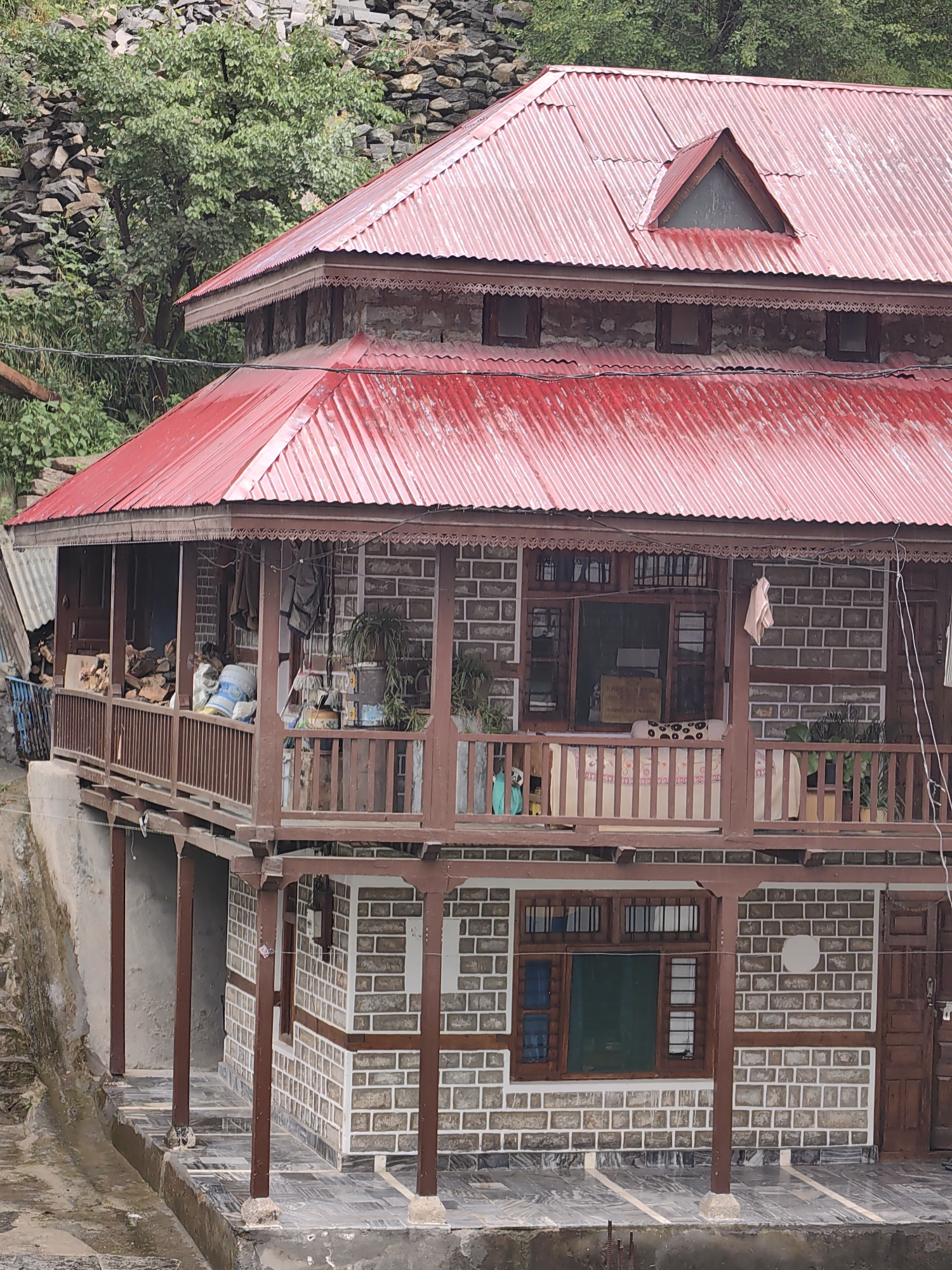 Morning mist and traditional architecture observed in Vashisht
