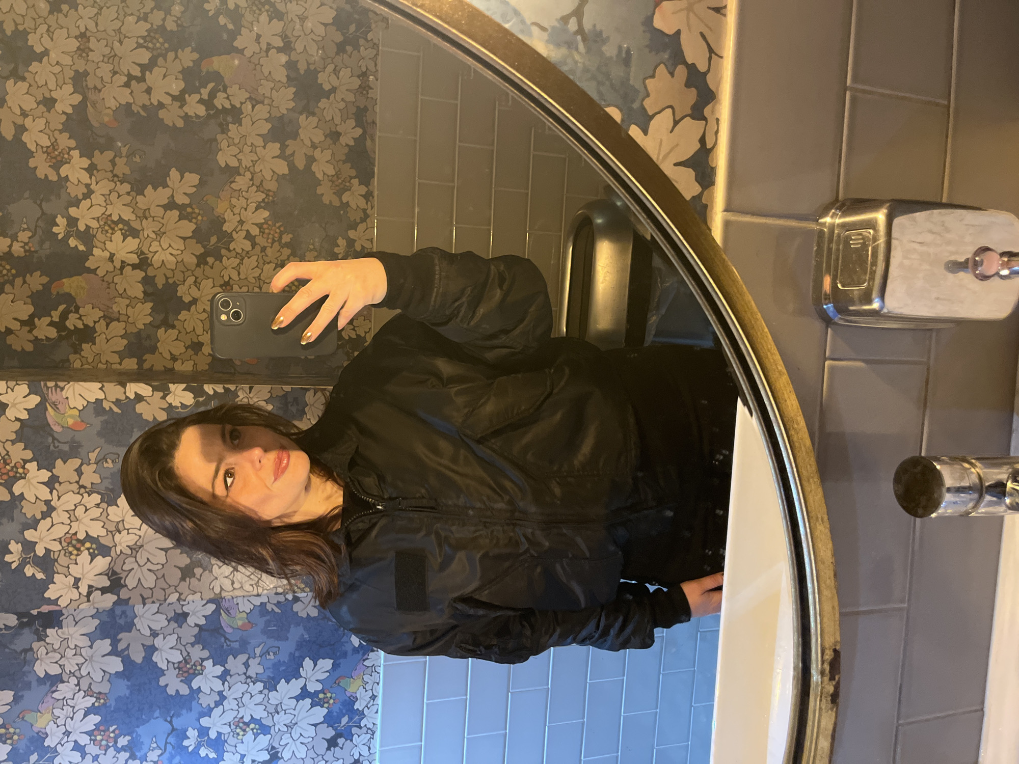 Woman Takes Selfie in London Public Restroom Mirror