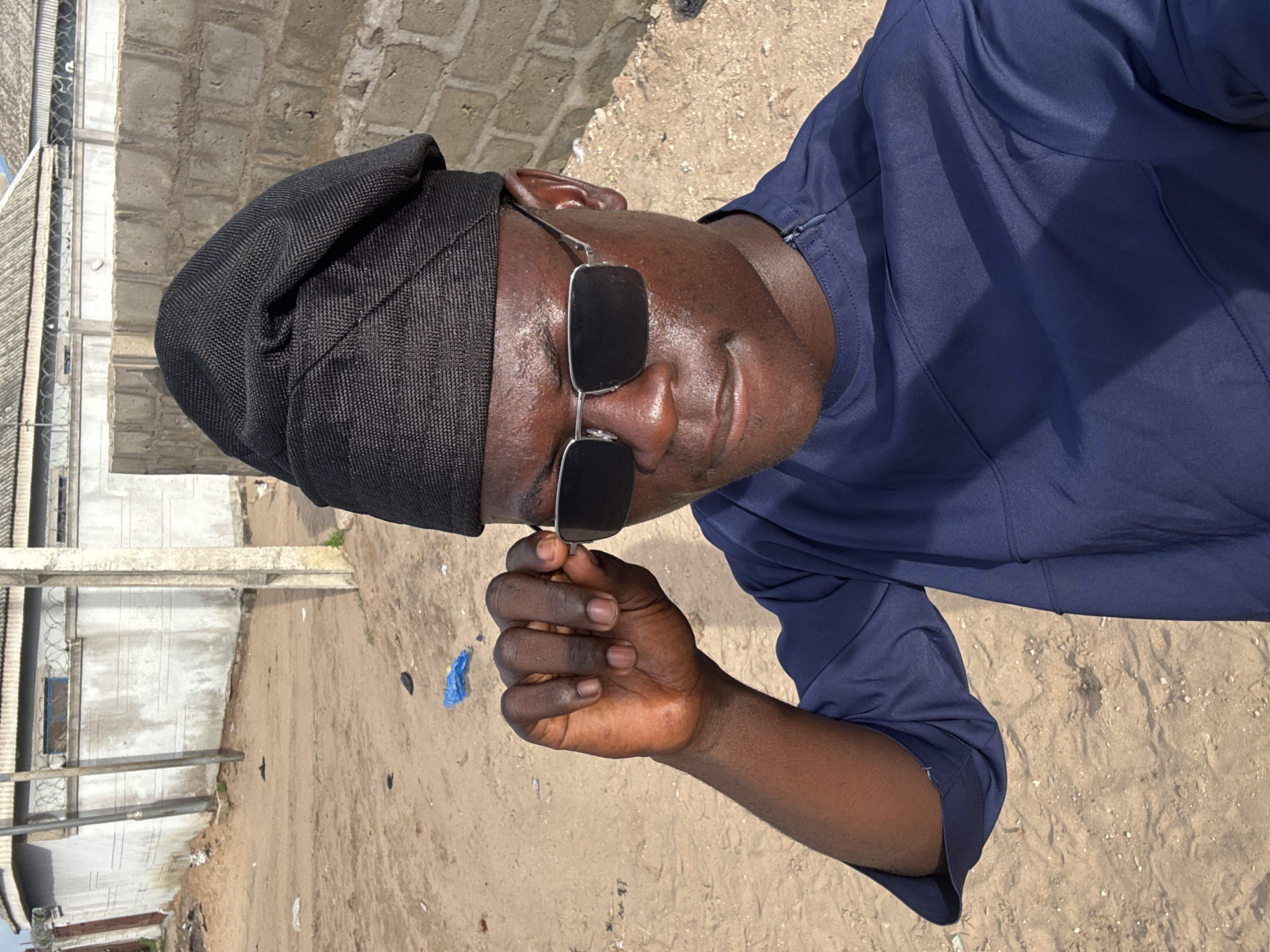 Man in sunglasses photographed multiple times in Badagry, Nigeria
