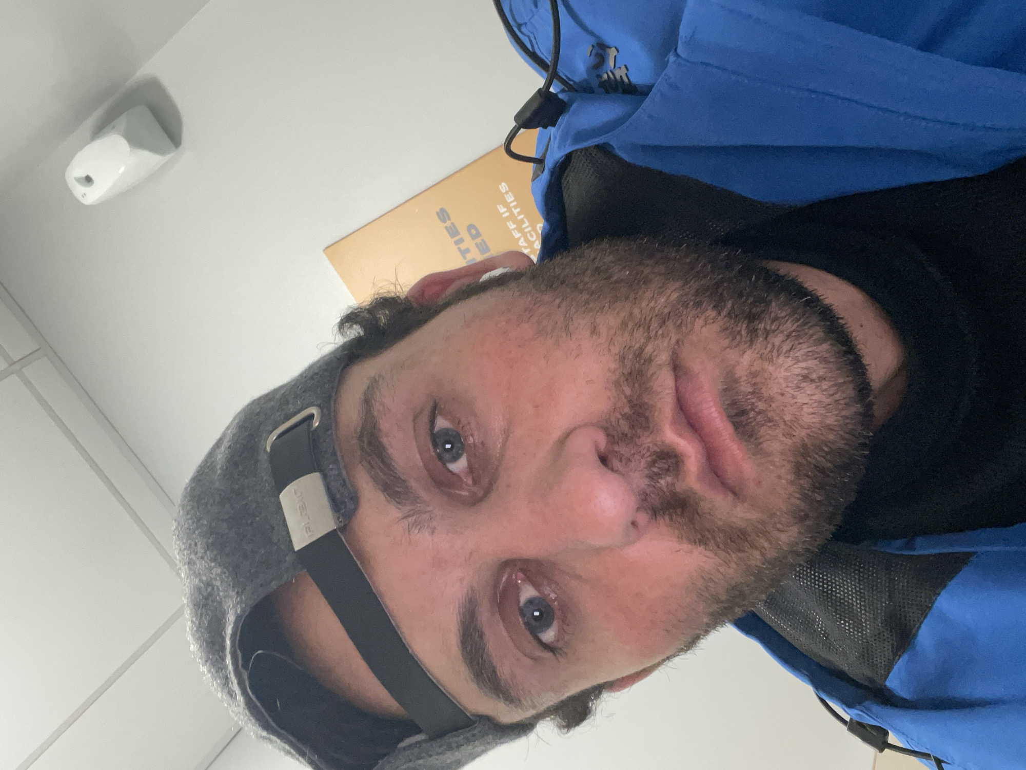 Man takes indoor selfie in Newry with facilities document visible