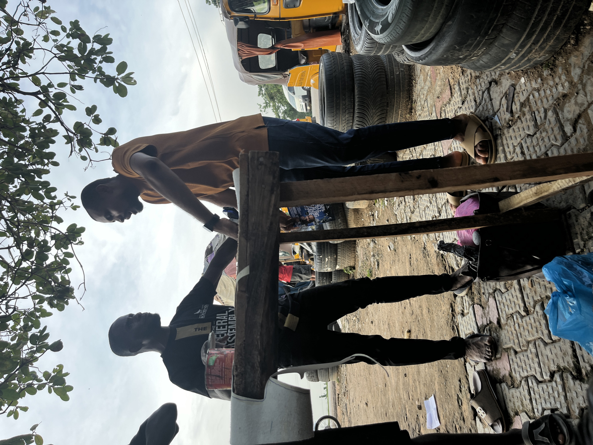 Everyday street life along a busy Abuja roadside