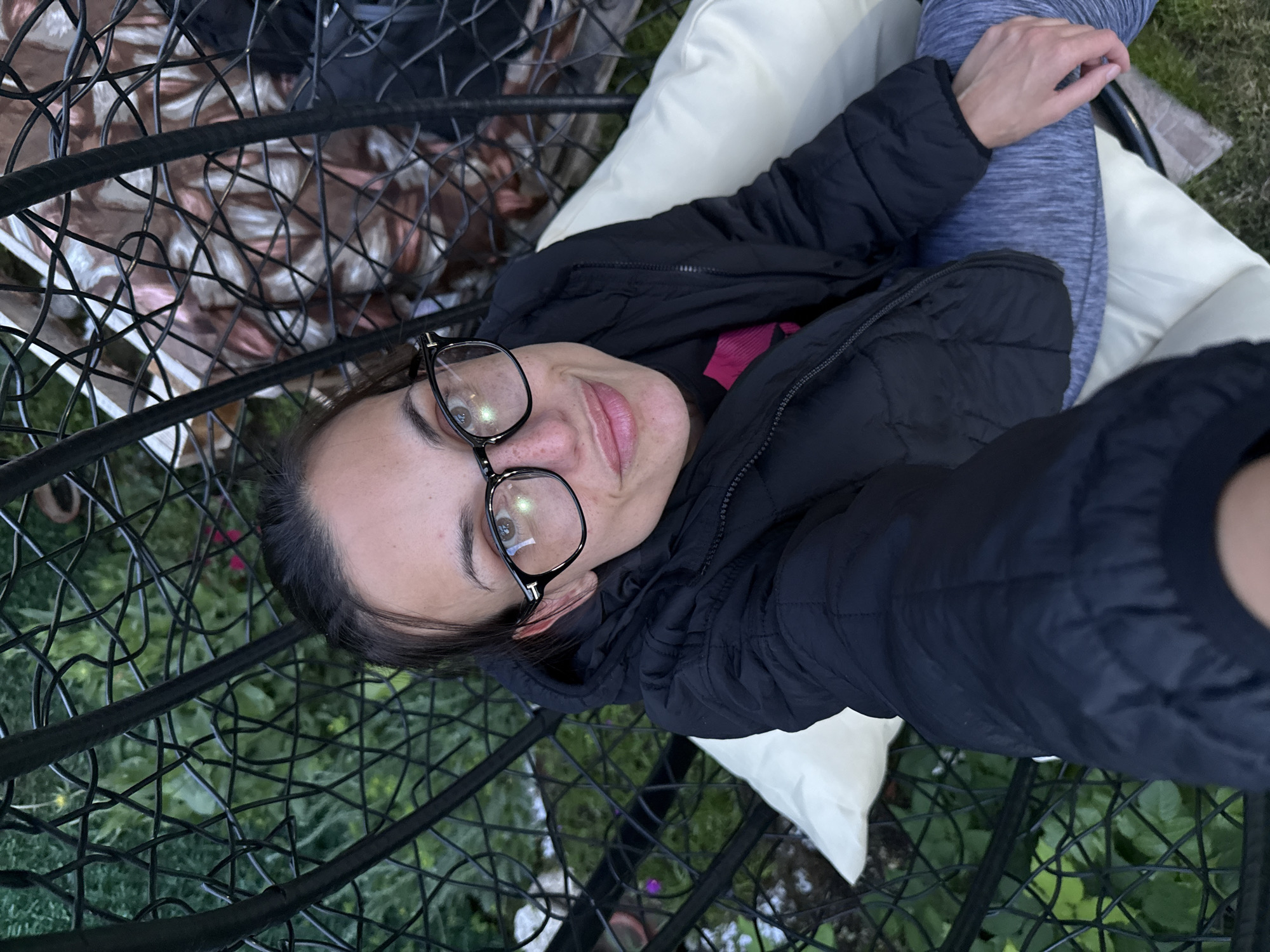 Woman enjoys quiet evening with dog in Pleven garden