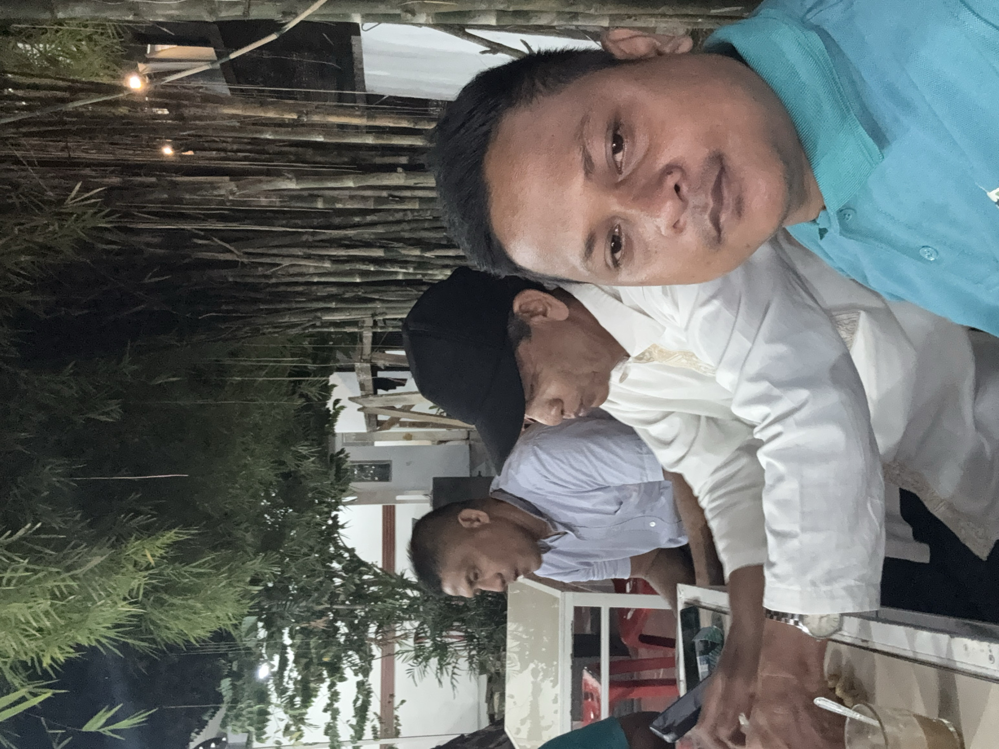 Men gather for casual outdoor meal in Lhokseumawe