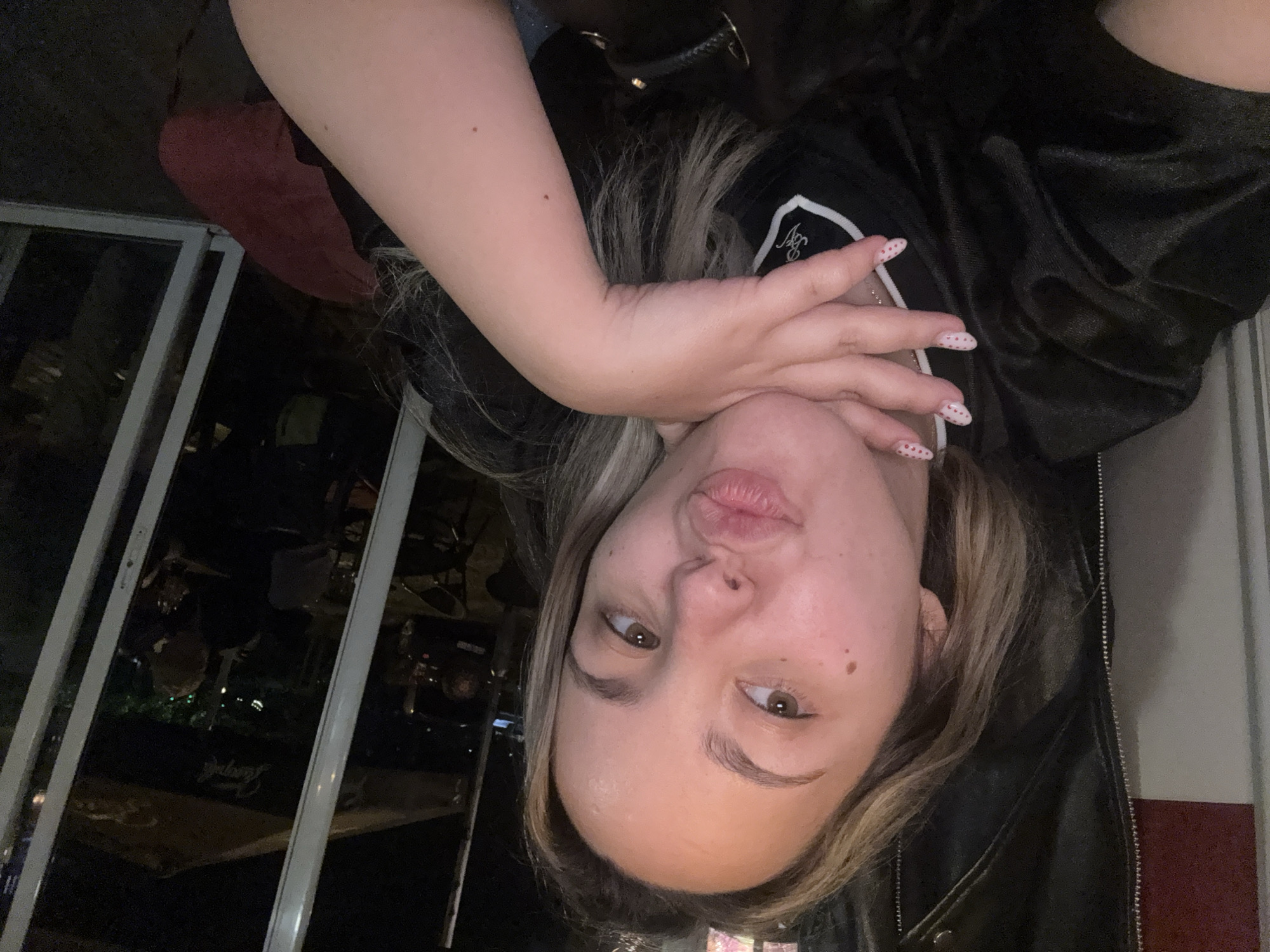 Woman takes playful upside-down selfie in Sofia, Bulgaria