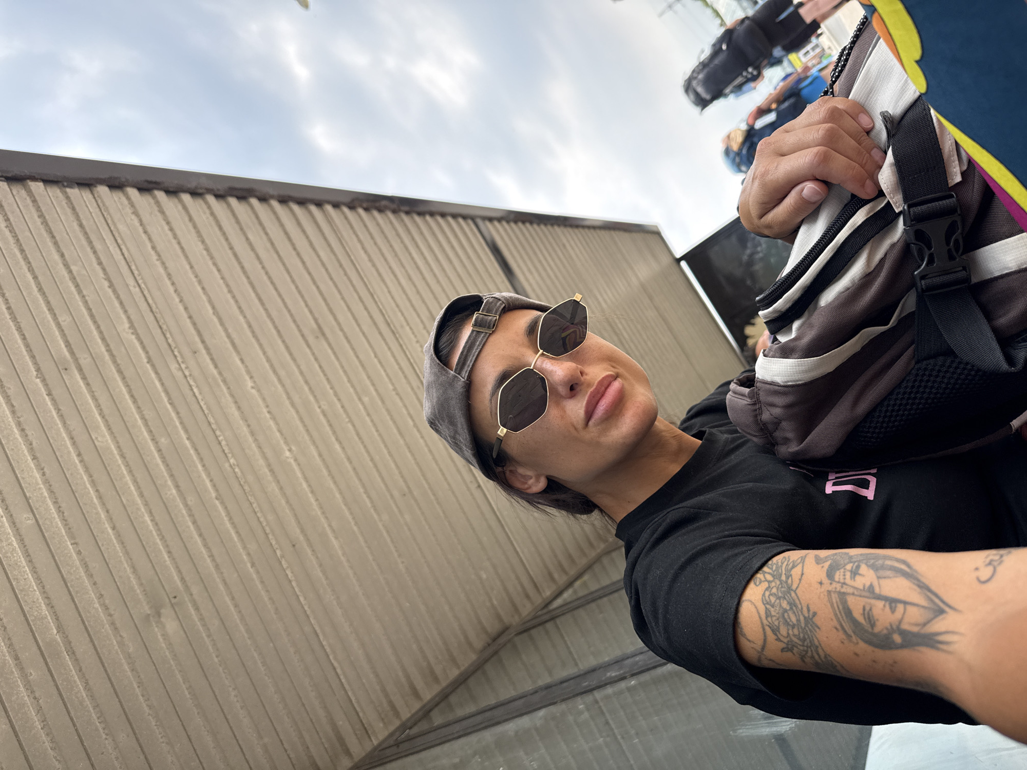 Low-angle street portraits in Prague, baseball cap and shades