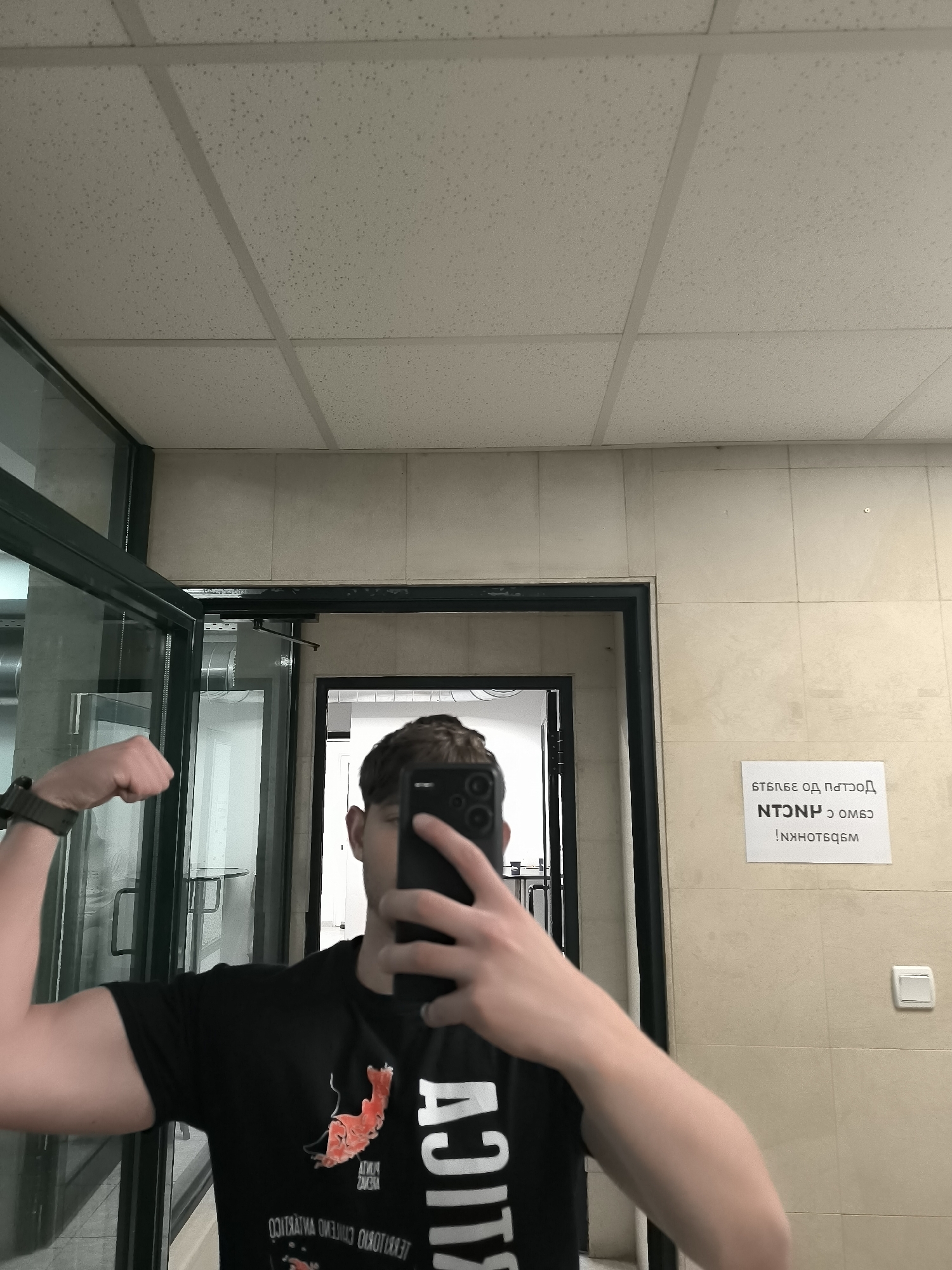 Person takes selfies while flexing indoors in Sofia