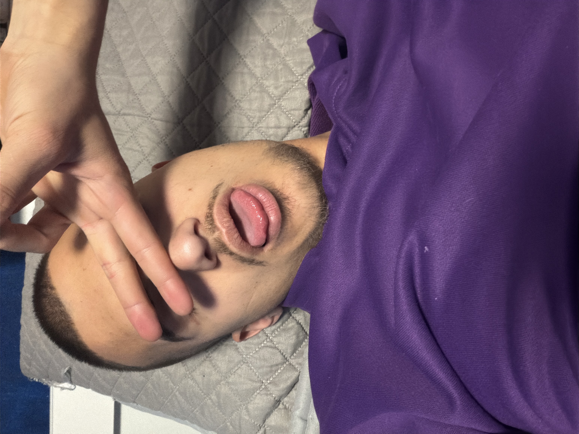 Person in purple photographed resting on quilted surface in Sofia