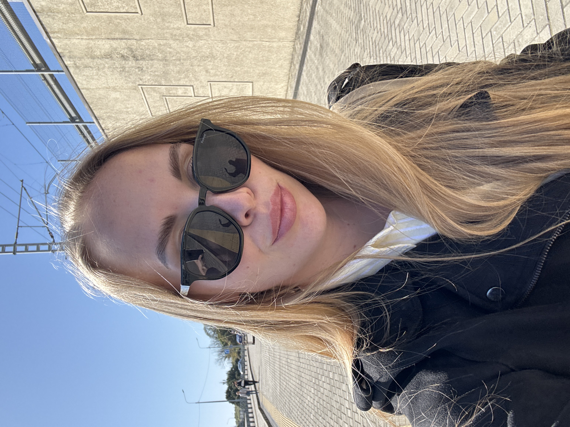 Woman takes selfie against mountain backdrop in Sirius, Russia