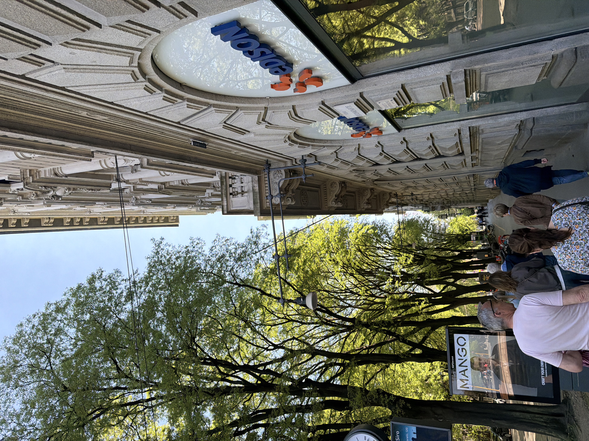 Tourist captures Milan landmarks during afternoon walking tour