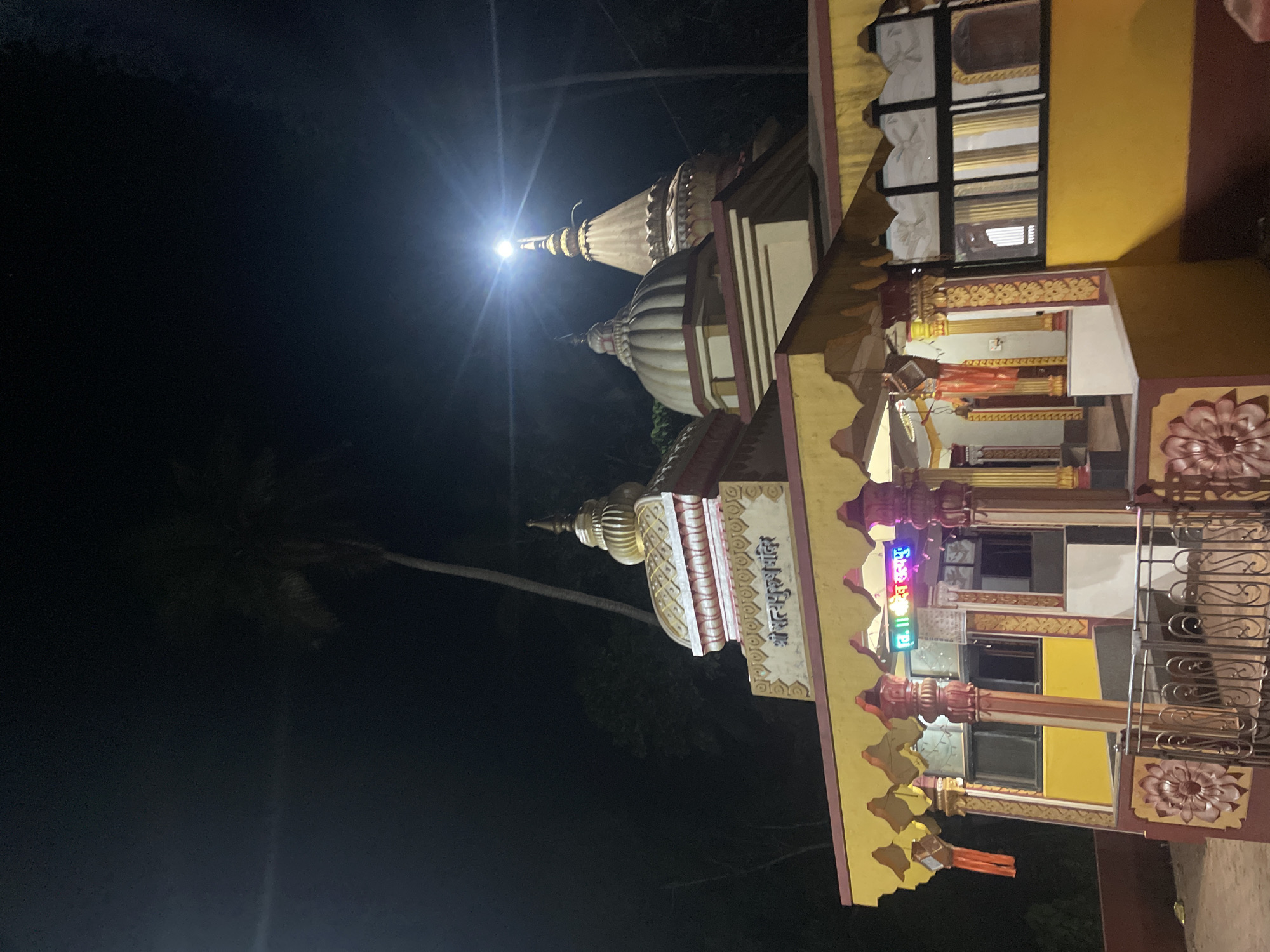 Hindu temple illuminated at night in Redi, India