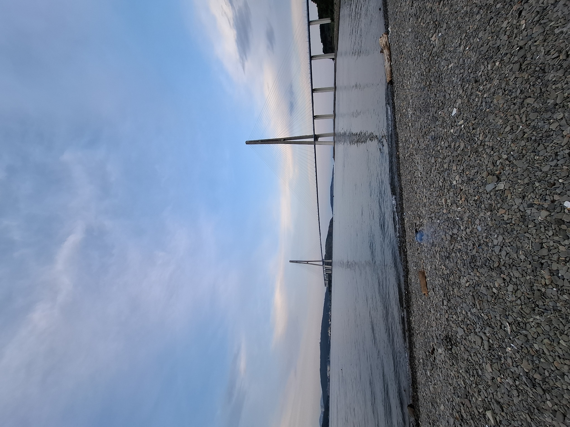 Dusk at Russky Island beach, bridge and shoreline in focus