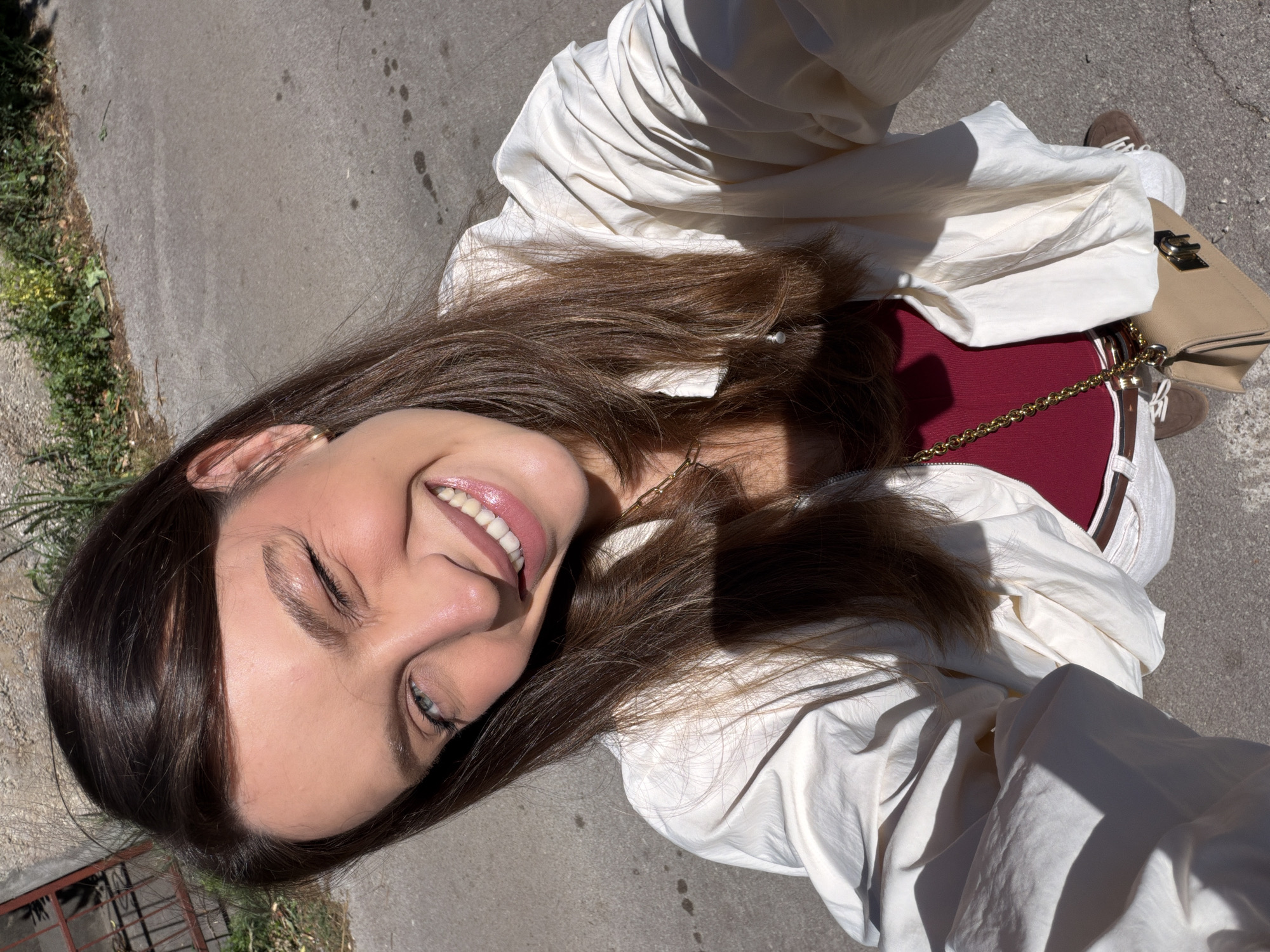 Woman films selfies on sunny streets in Budva, Montenegro