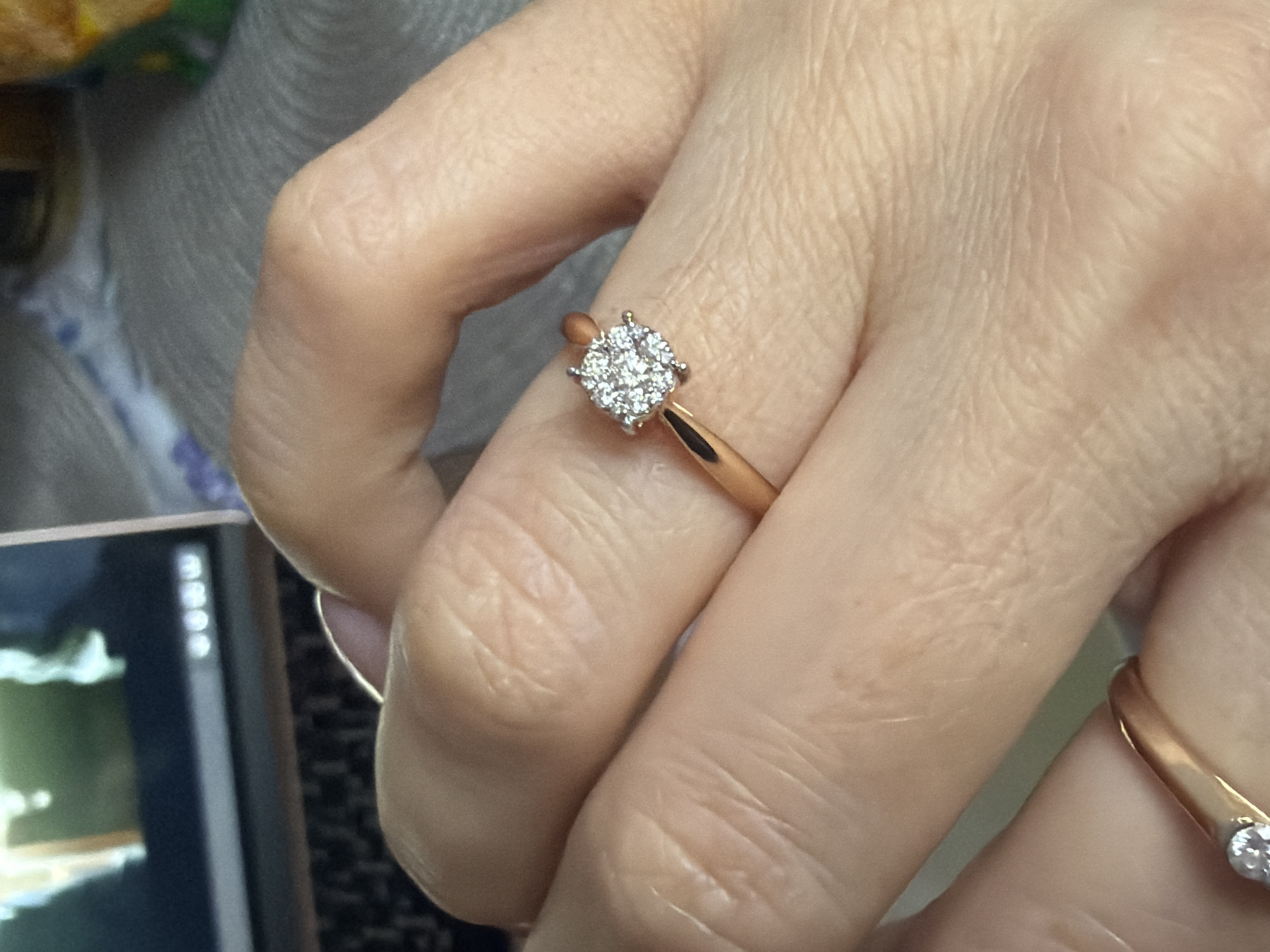 Person displays manicured hand with diamond rings in Saint Petersburg